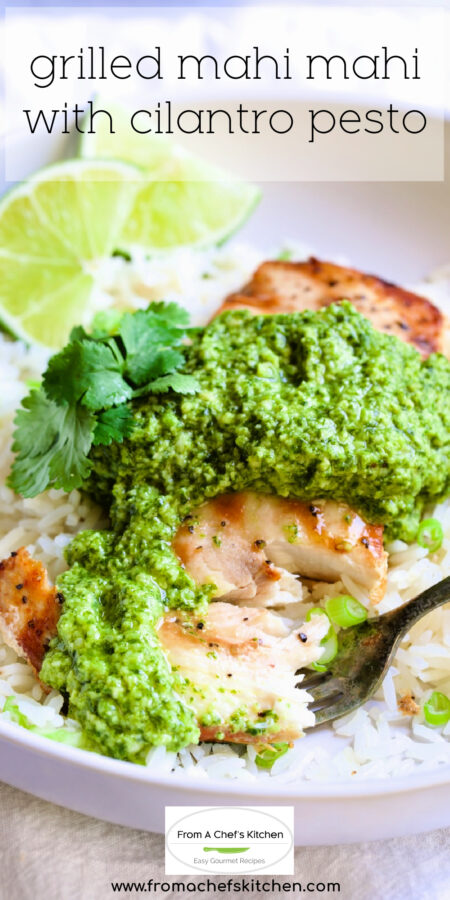 Pinterest graphic for Grilled Mahi Mahi with Cilantro Pesto showing it on a white plate over white rice with fork taking a piece.