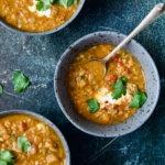 Three bowls of Ethiopian Red Lentil Vegetable Soup.