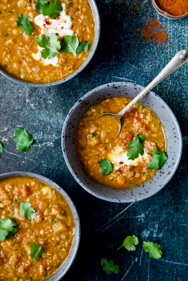 Three bowls of Ethiopian Red Lentil Vegetable Soup.