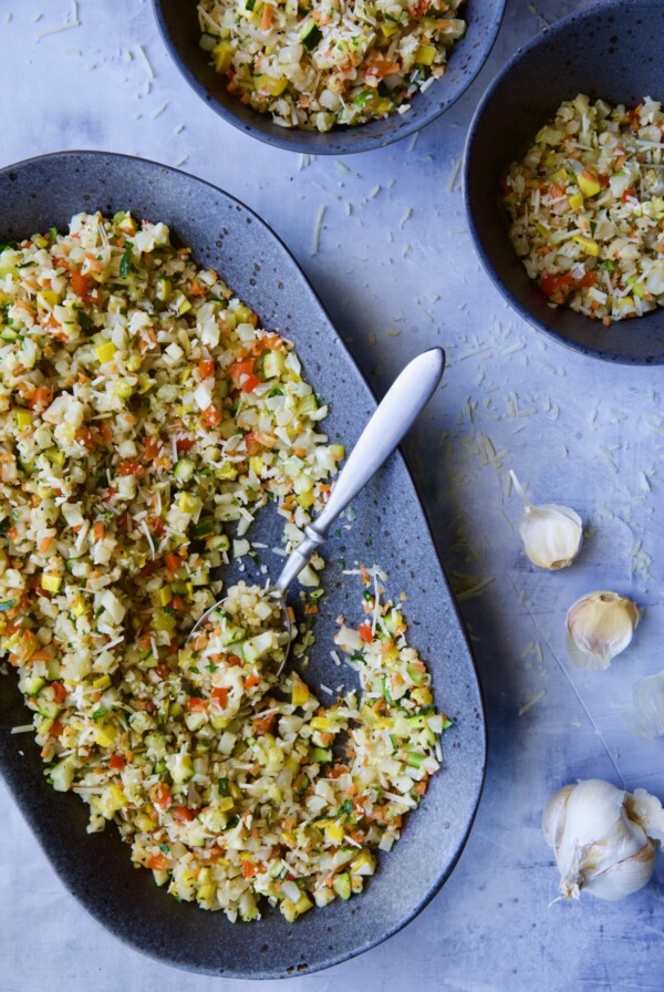 Garlic Parmesan Roasted Riced Vegetables on platter with it being served into two bowls.