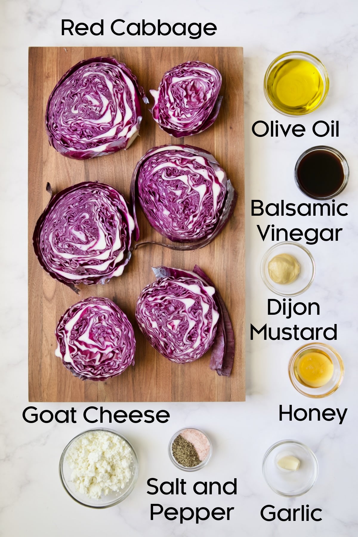 Ingredients for Roasted Red Cabbage Steaks with Balsamic Vinaigrette and Goat Cheese in glass bowls.