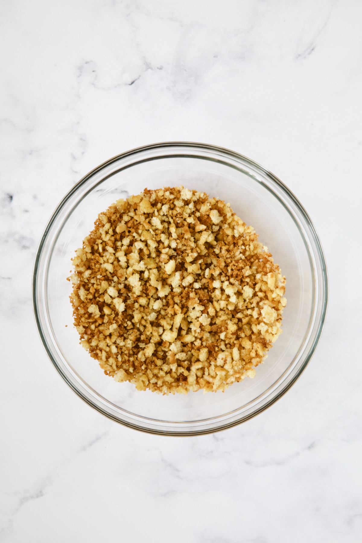Toasted breadcrumbs in glass bowl.