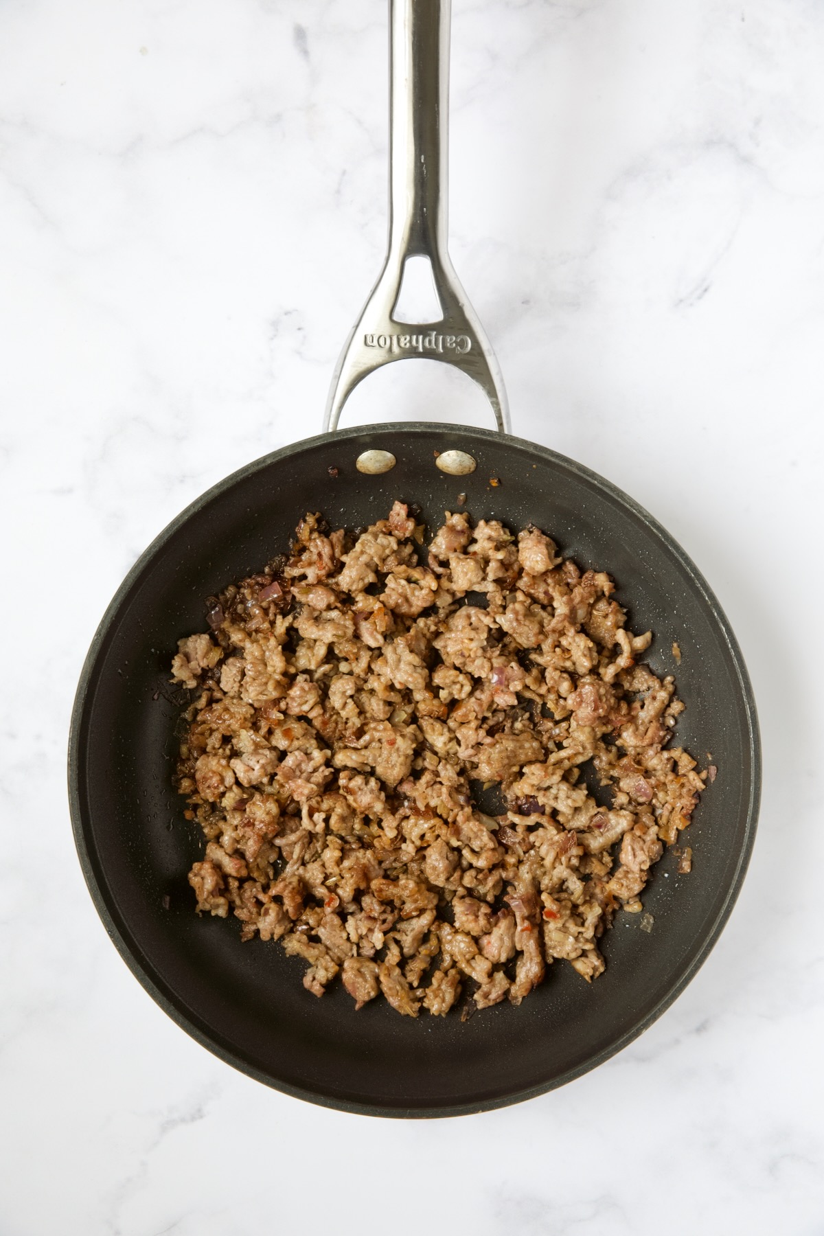 Cooked Italian sausage in nonstick skillet.