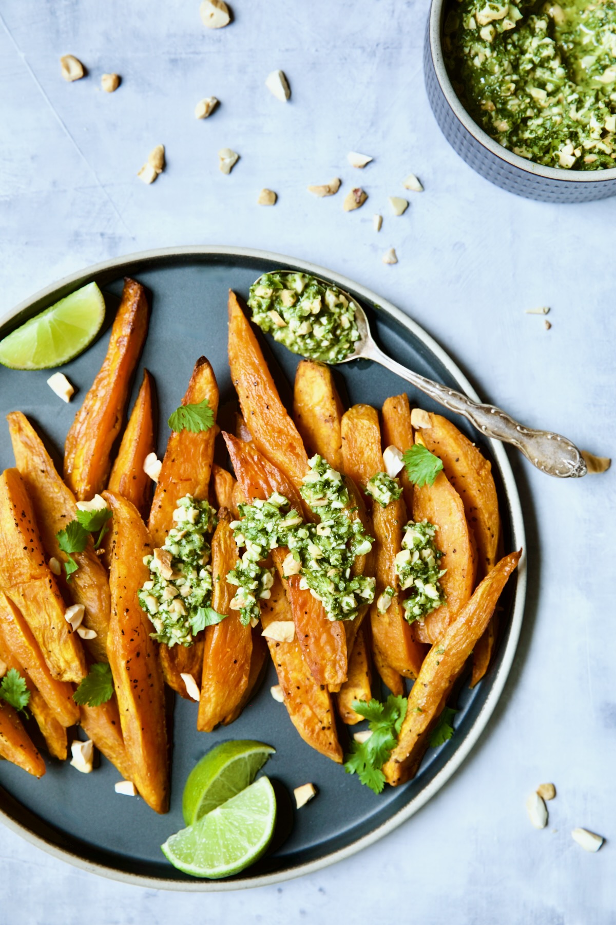 Roasted Sweet Potato Wedges with Cilantro - Cashew Sauce on round plate.