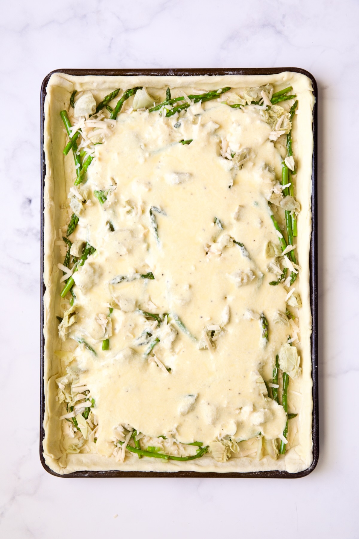Puff pastry tart after custard is added and before goat cheese is added.