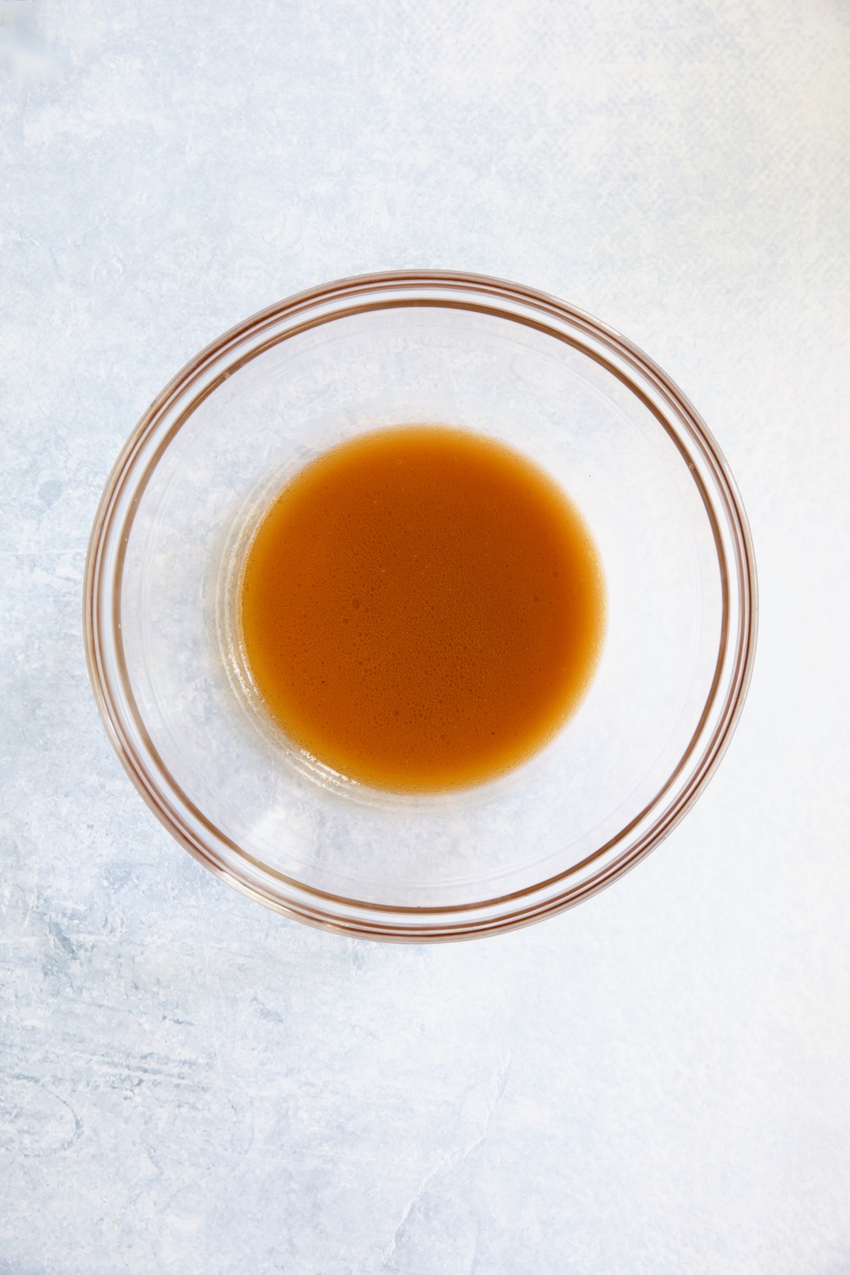 Salad dressing in glass bowl.