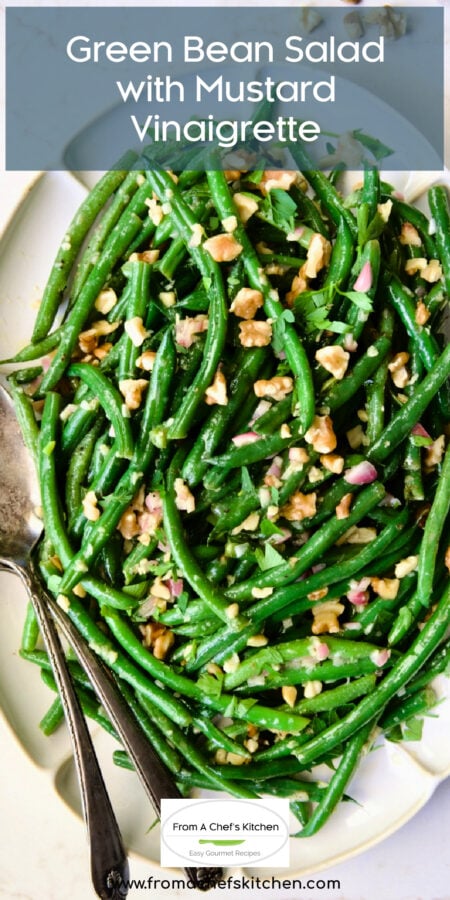 Pinterest graphic for Green Bean Salad with Mustard Vinaigrette with the salad on white platter with serving utensils.