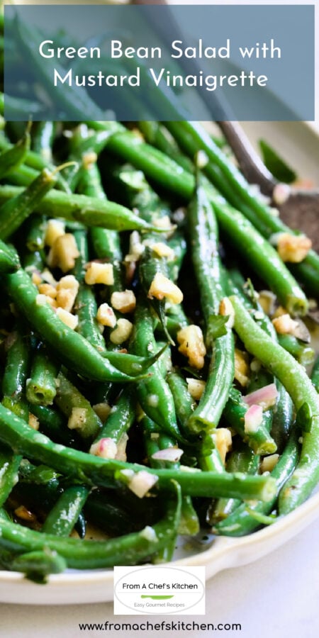 Pinterest graphic for Green Bean Salad with Mustard Vinaigrette with the salad on white platter with serving utensils.