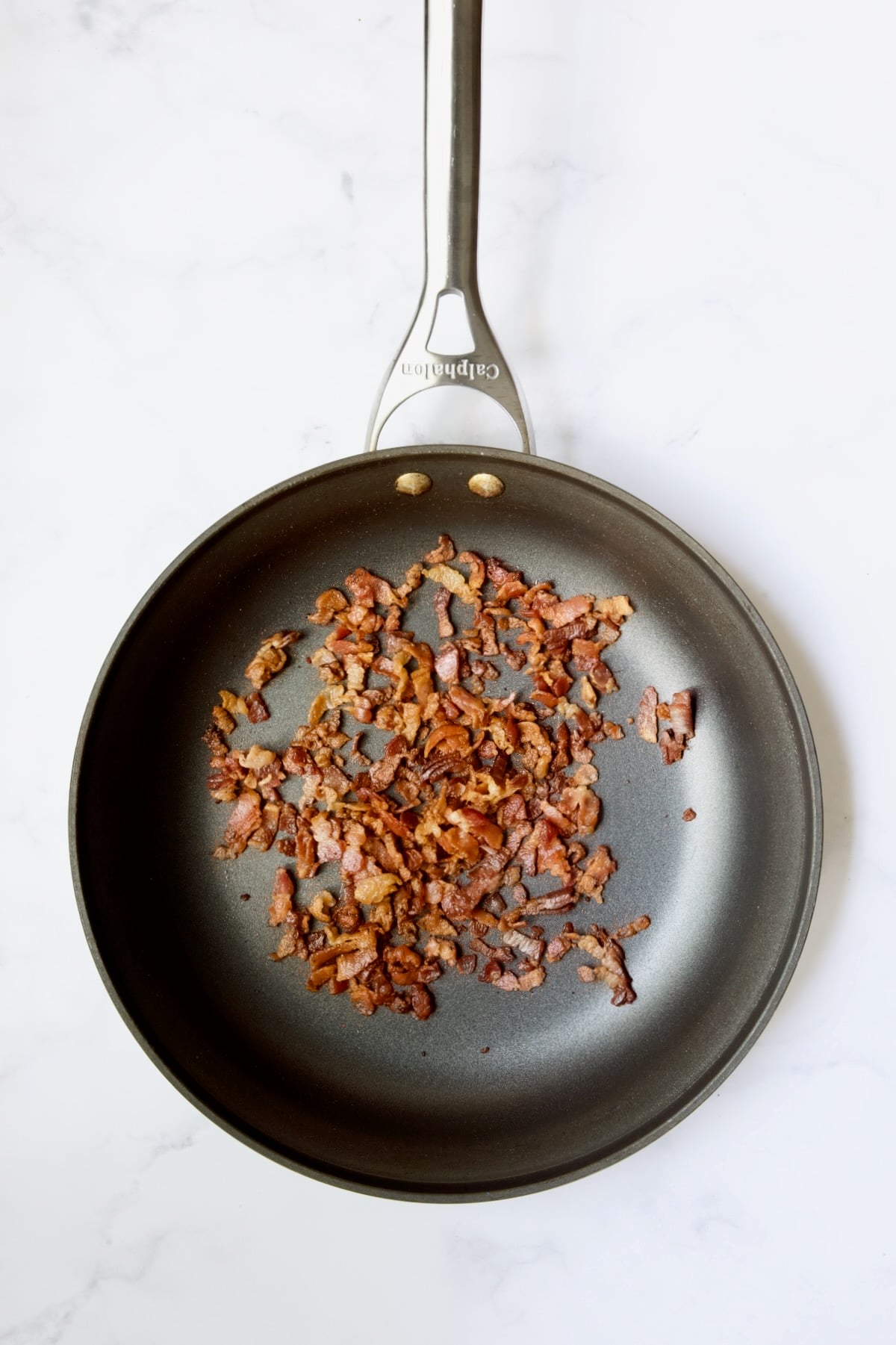 Cooked bacon in skillet.