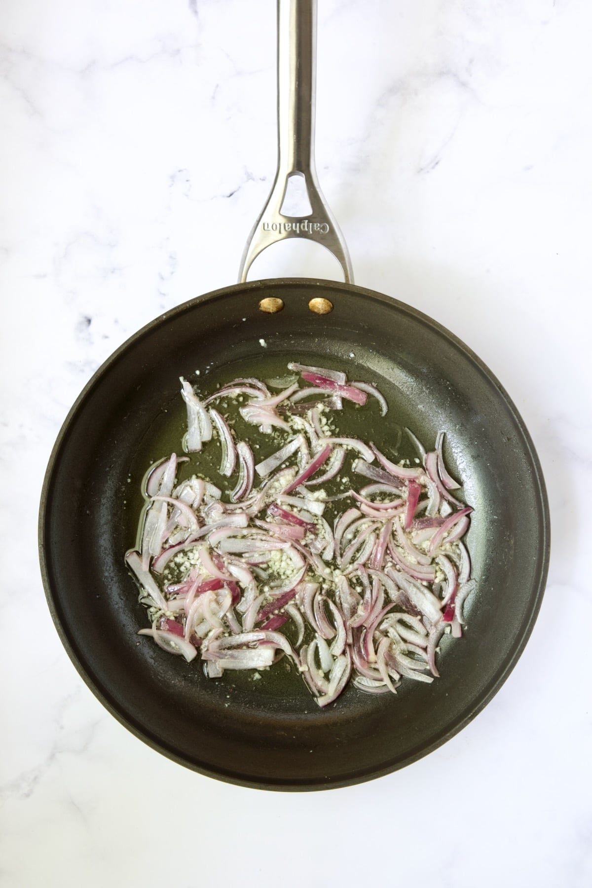 Cooked onions and garlic in skillet.