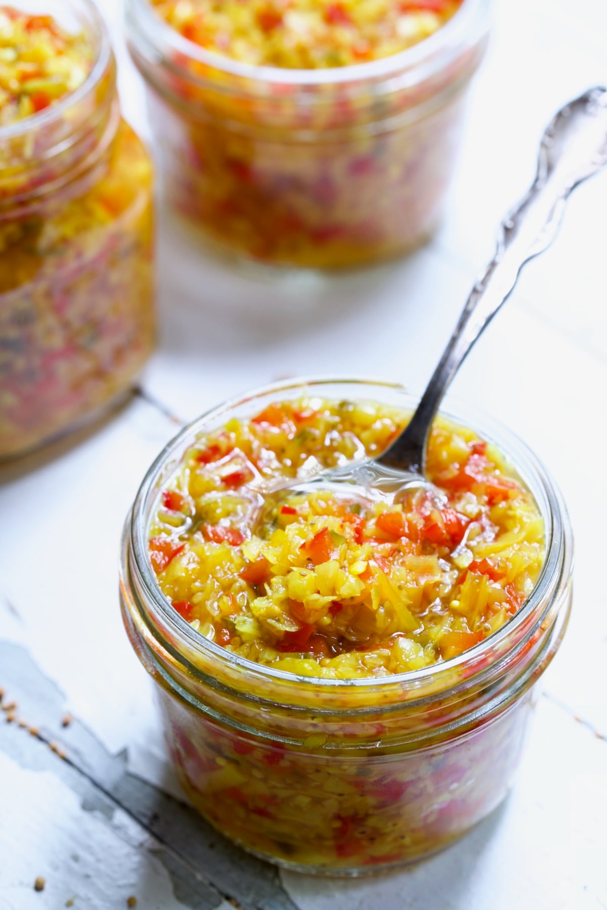 Ramp and Pepper Relish Recipe in glass jar with spoon.