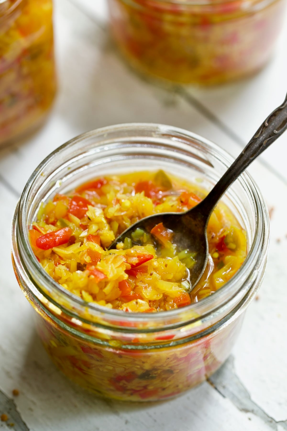 Ramp and Pepper Relish Recipe in glass jar with spoon.