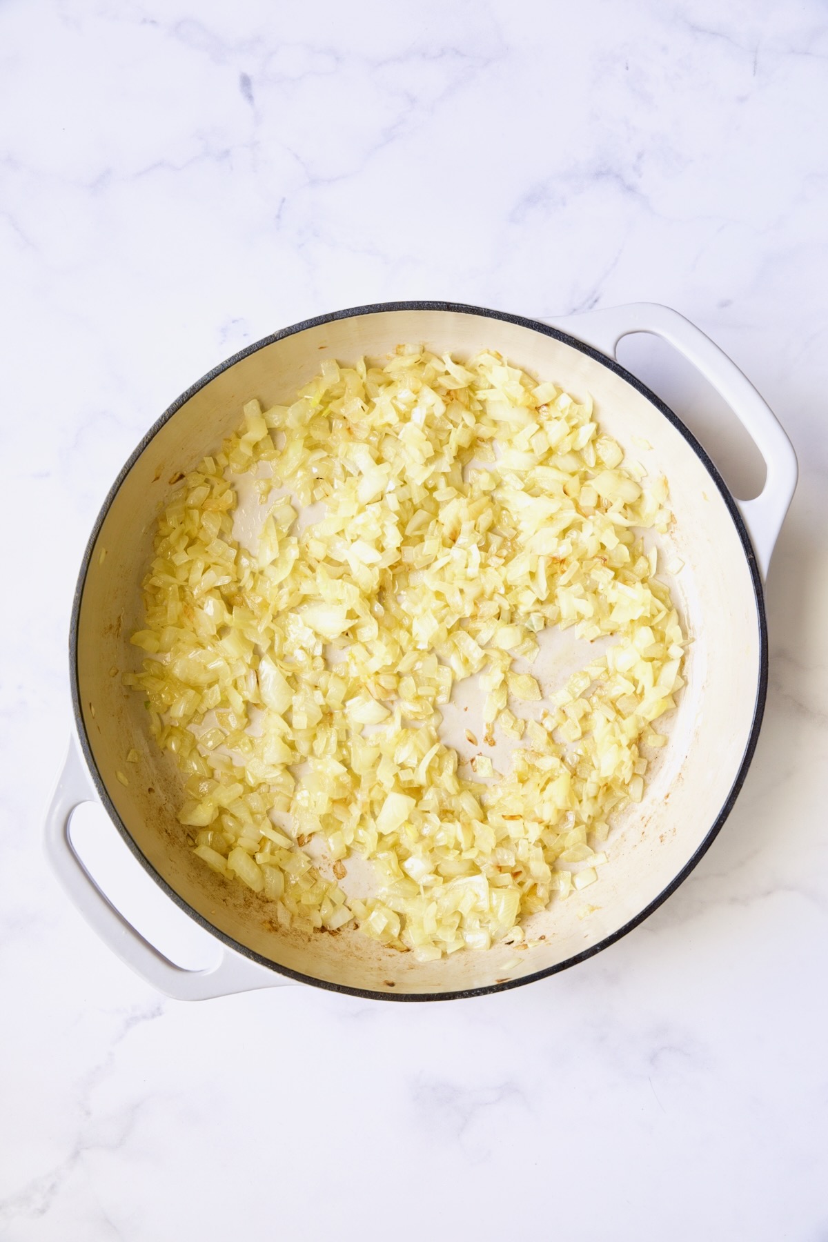 Sauteed onions in white enamel cast iron skillet.