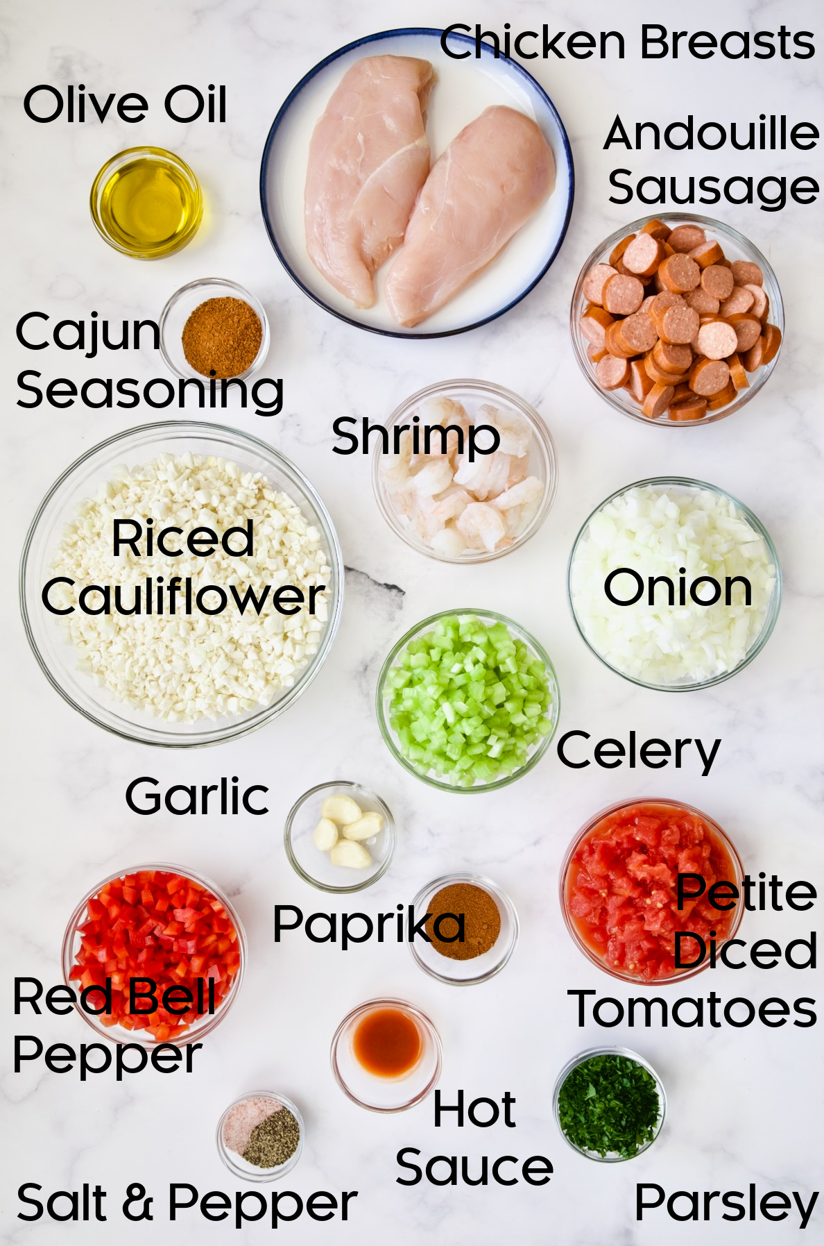 Ingredients for Low-Carb Jambalaya with Chicken Shrimp and Sausage in glass bowls.