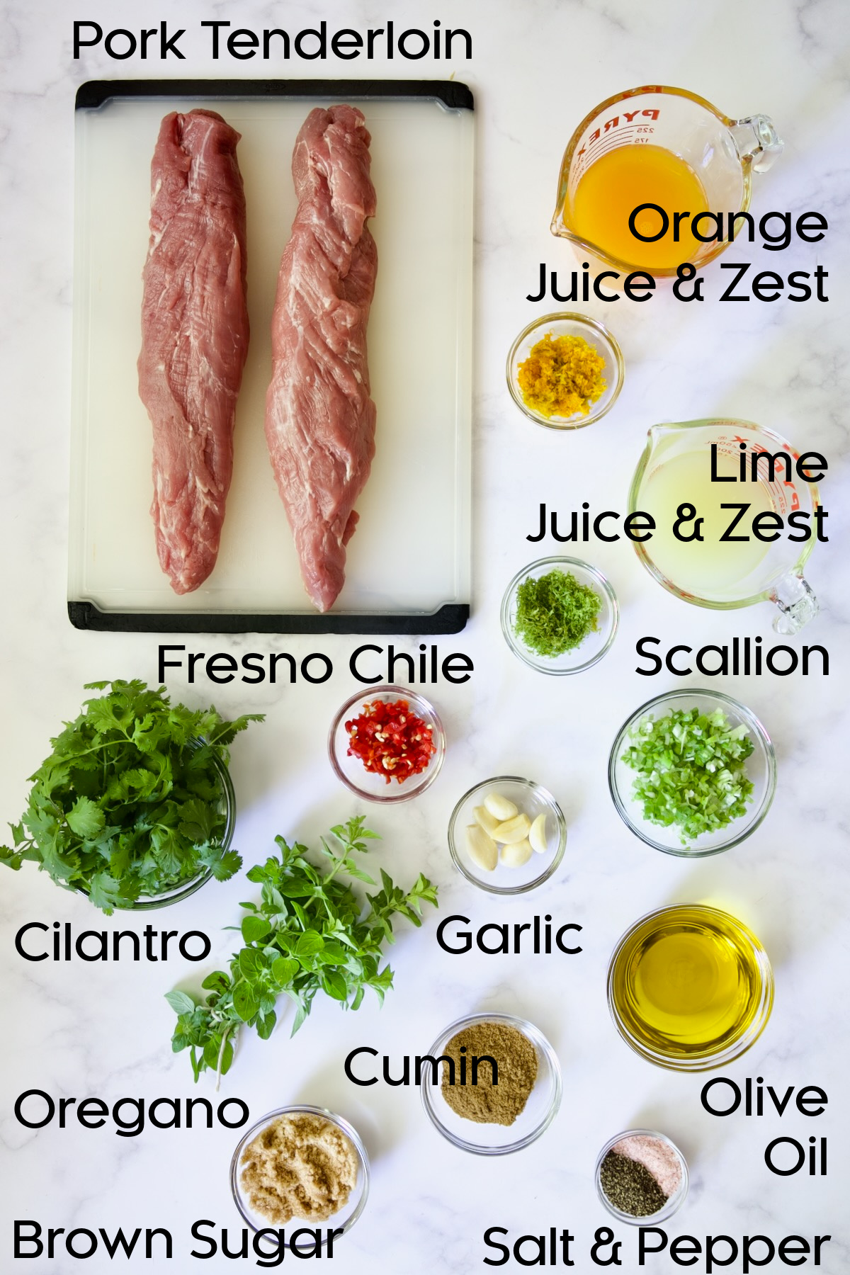 Ingredients for Mojo-Marinated Pork Skewers in glass bowls.