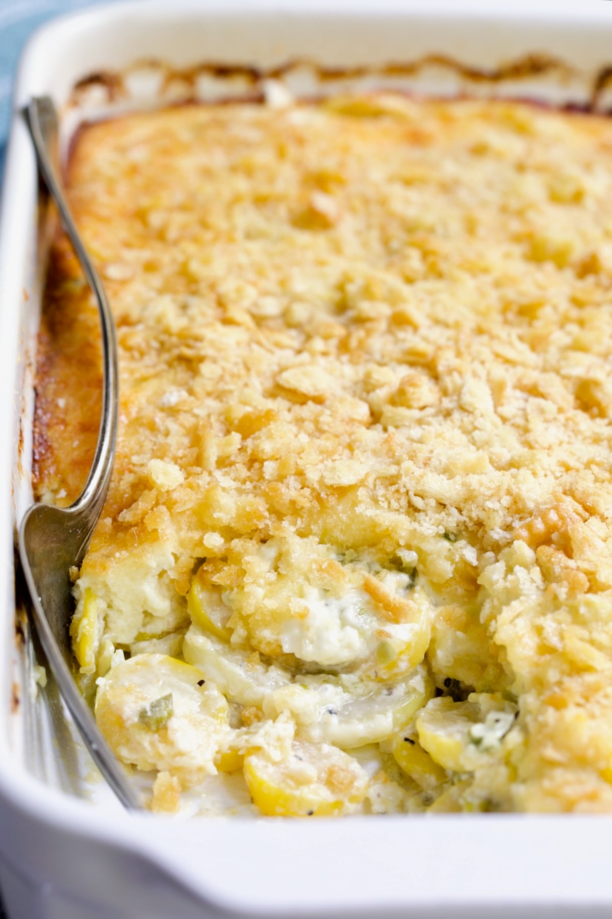 Southwestern Summer Squash Casserole in white baking dish with serving fork.
