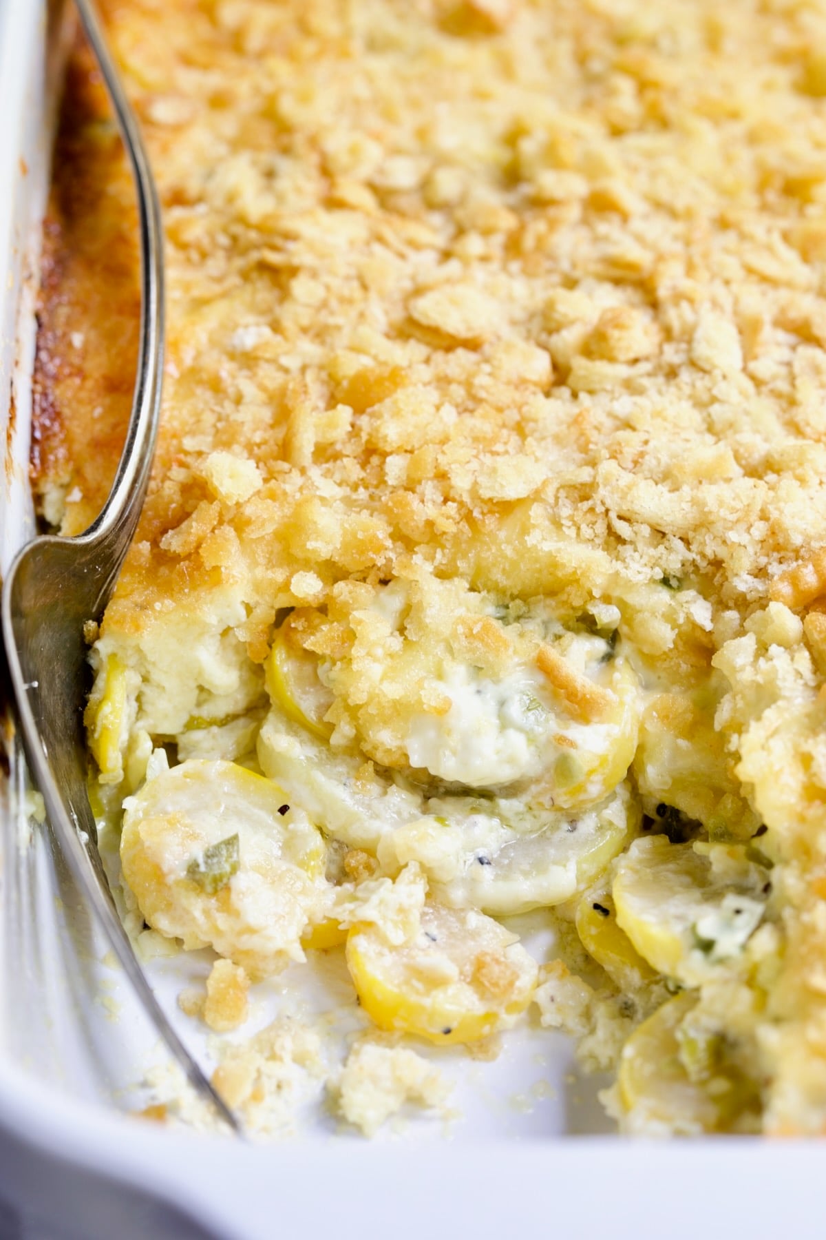 Southwestern Summer Squash Casserole in white baking dish with squash exposed.