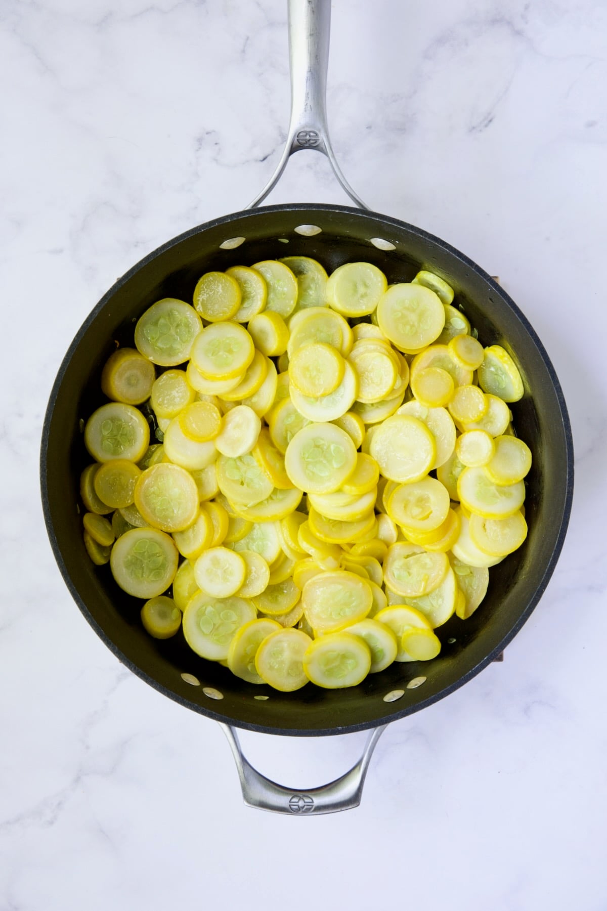 Cooked yellow squash in nonstick skillet.