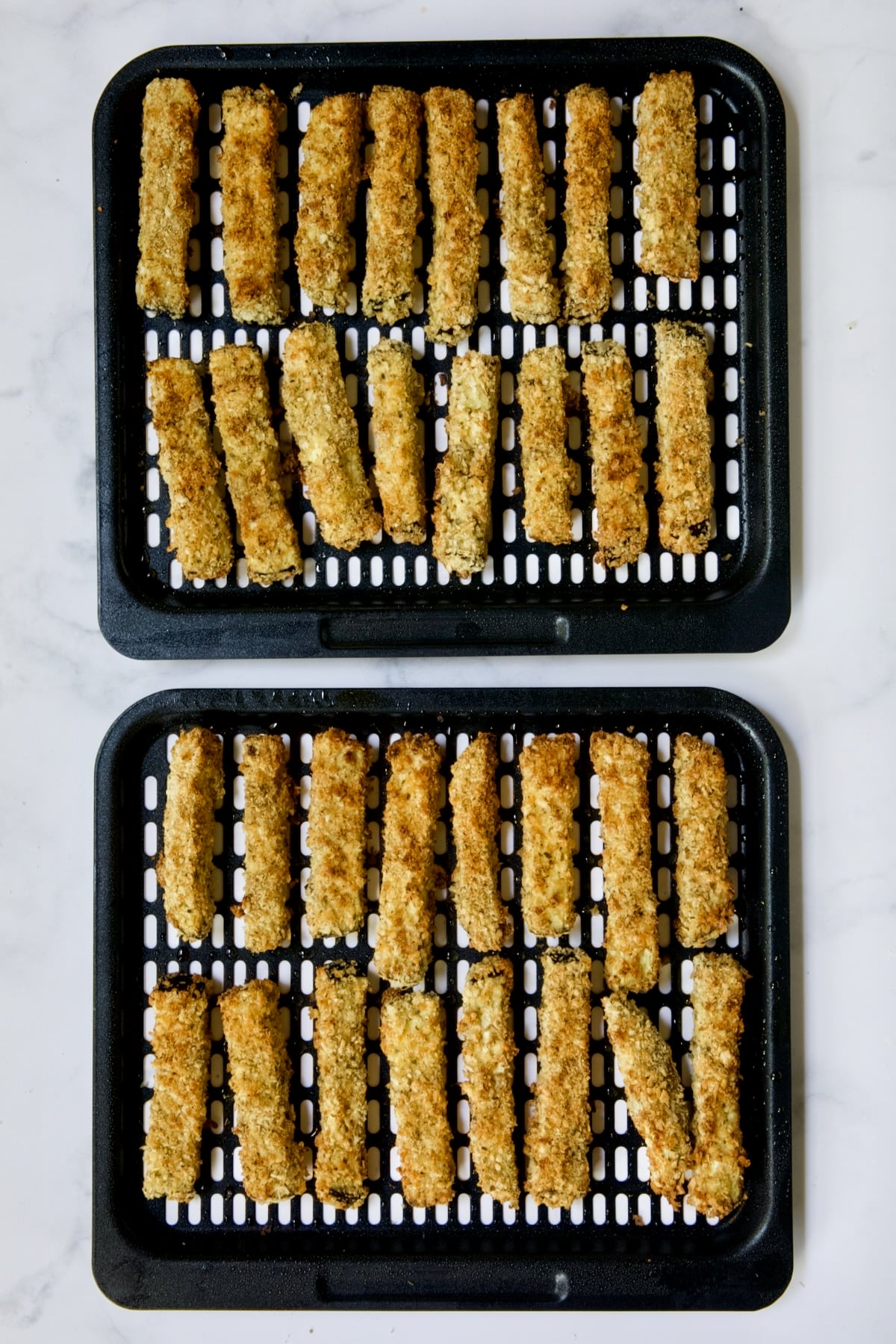 Two trays of finished eggplant fries.