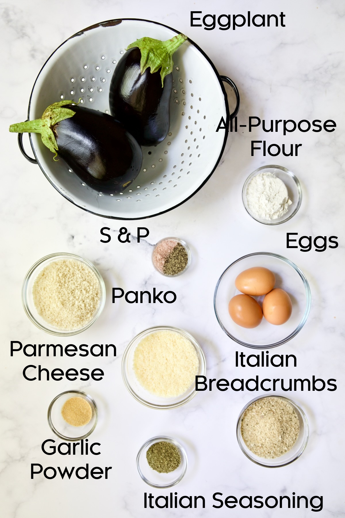 Ingredients for Air Fryer Eggplant Fries on white marble background.