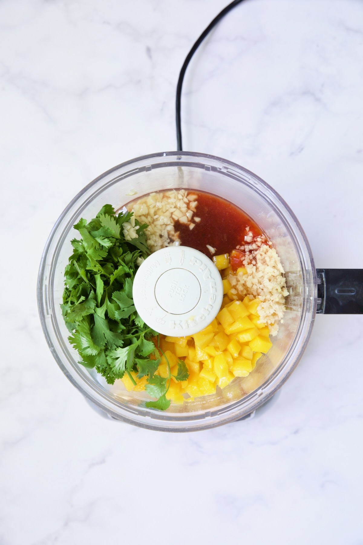 Ingredients for Sweet Chili Vinaigrette in food processor before being pureed.