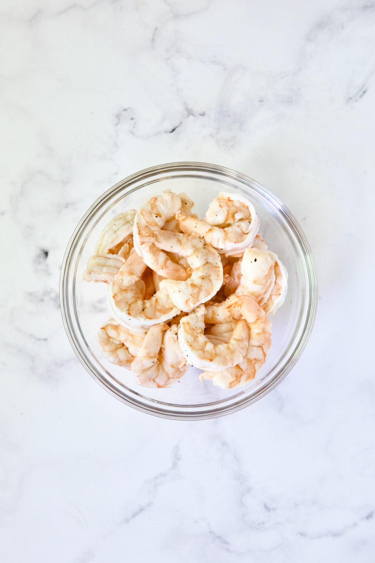 Cooked shrimp in glass bowl.