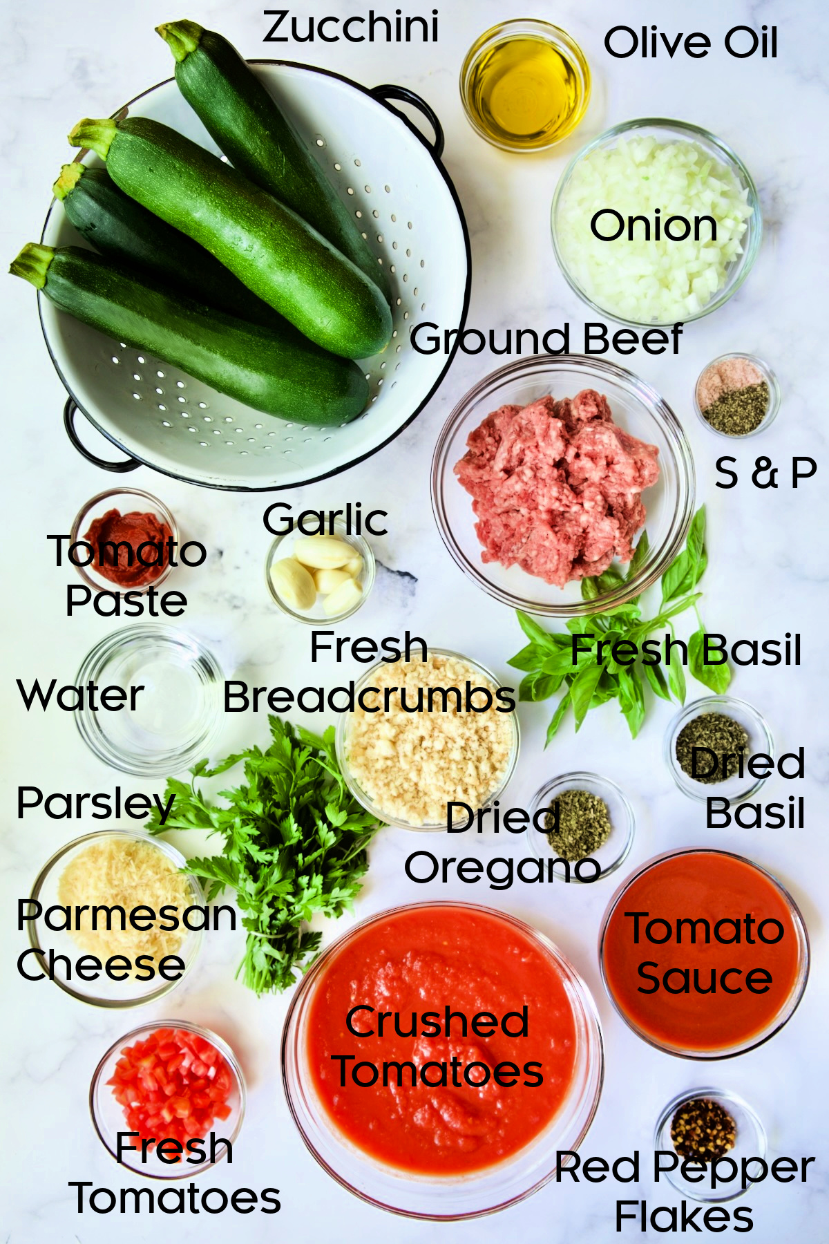 Ingredients for Meat-Stuffed Zucchini with Tomato Sauce in glass bowls.