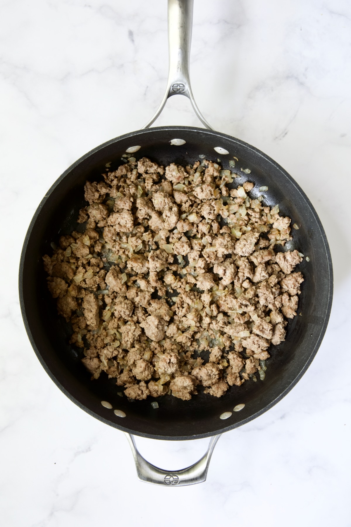 Browned ground beef in nonstick skillet.