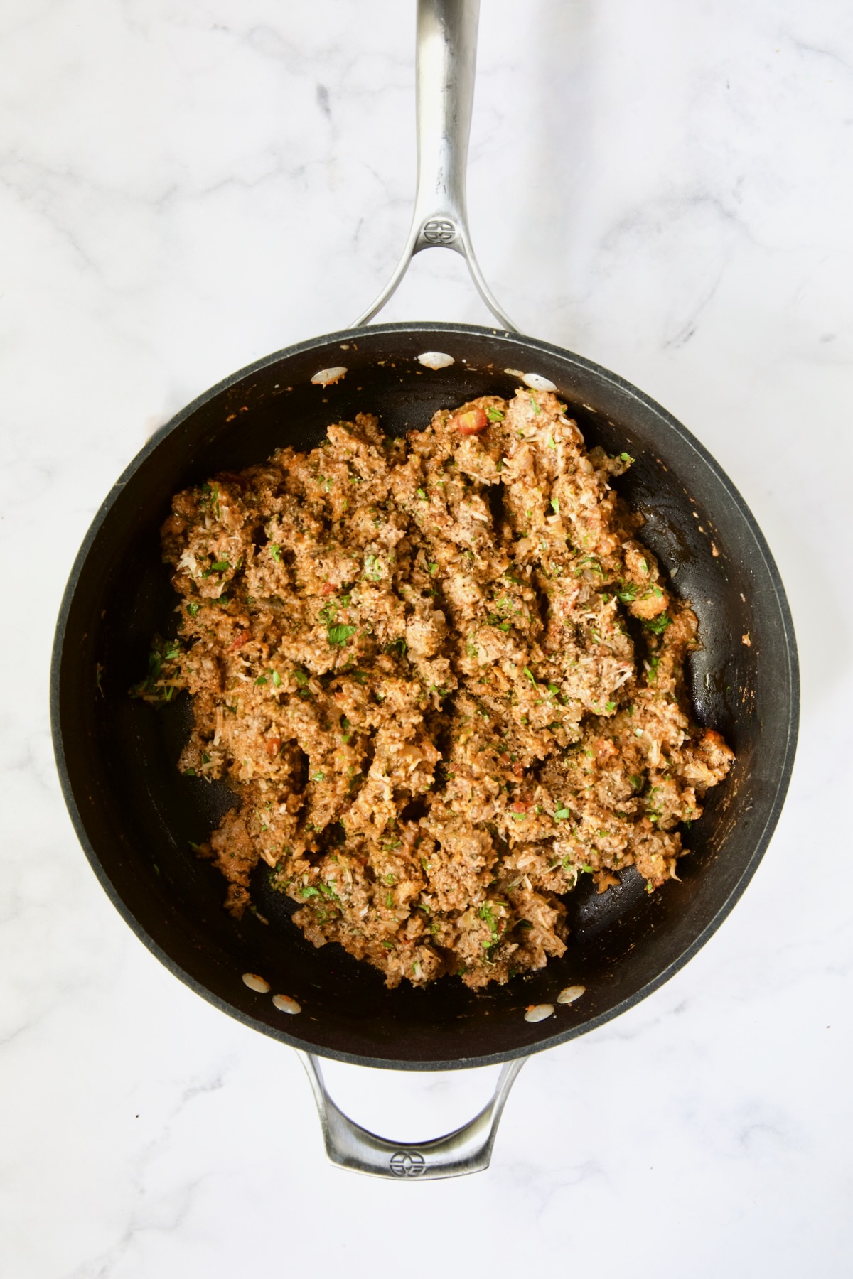 Filling for meat-stuffed zucchini in nonstick skillet.