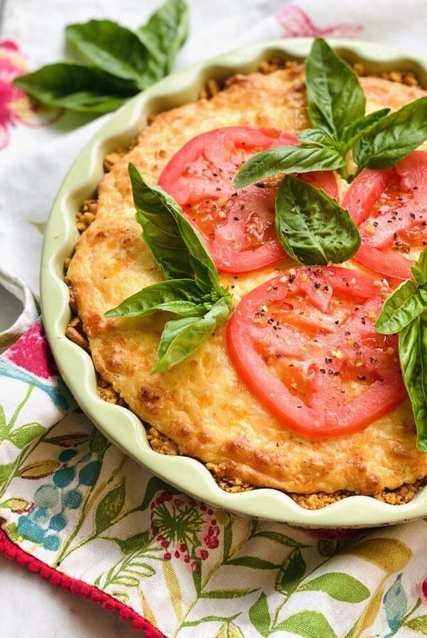 Southern Tomato Pie garnished with fresh basil.
