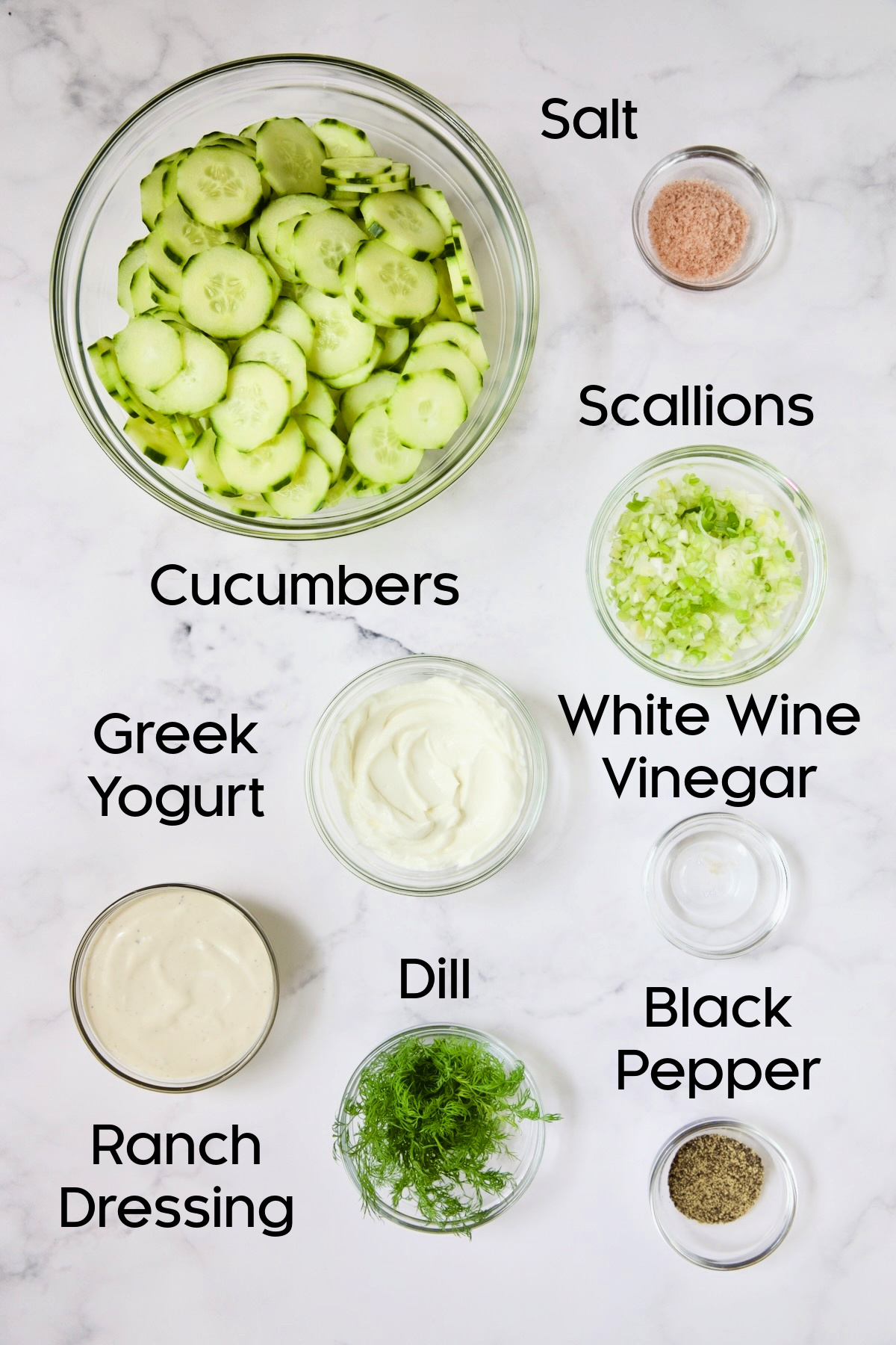 Ingredients for Yogurt Ranch Cucumber Salad in glass bowls.