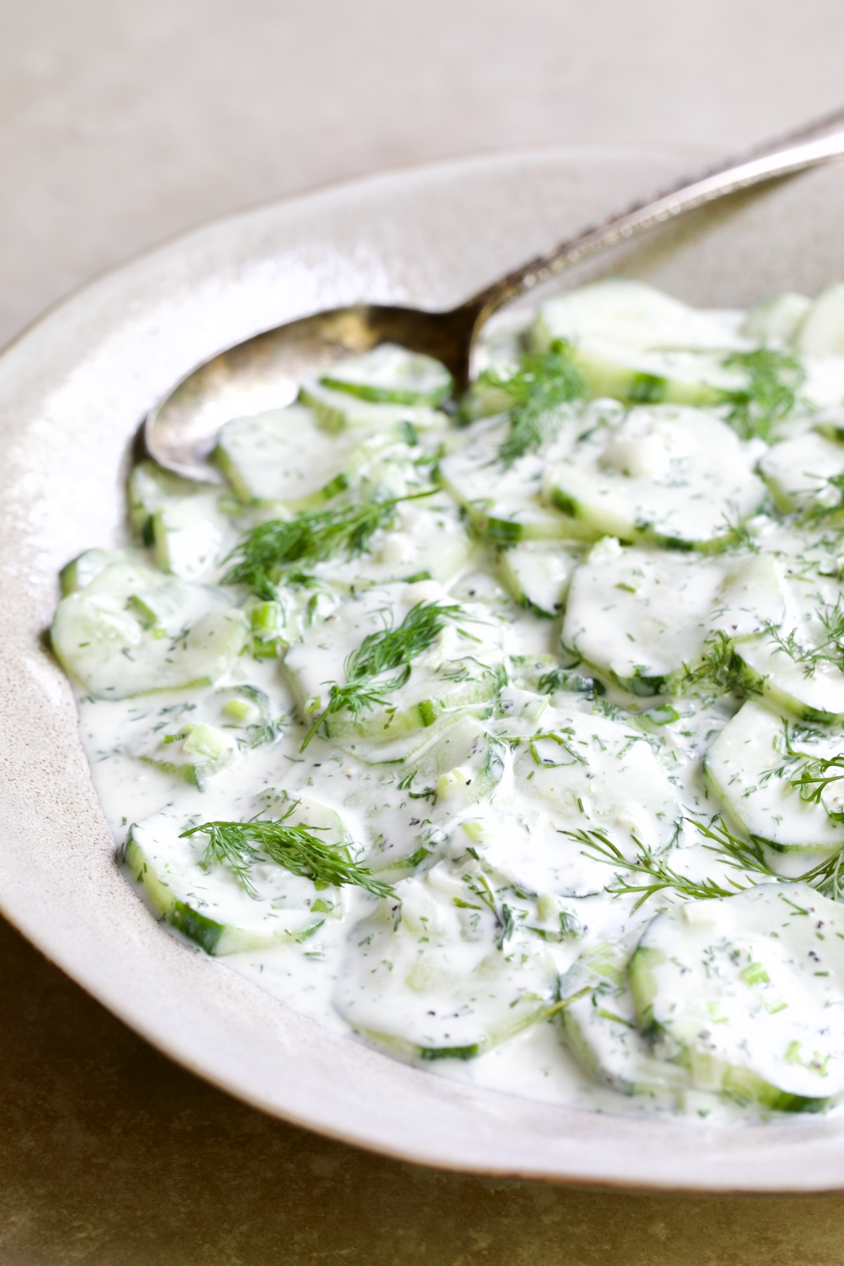 Yogurt Ranch Cucumber Salad in serving bowl with serving spoon.