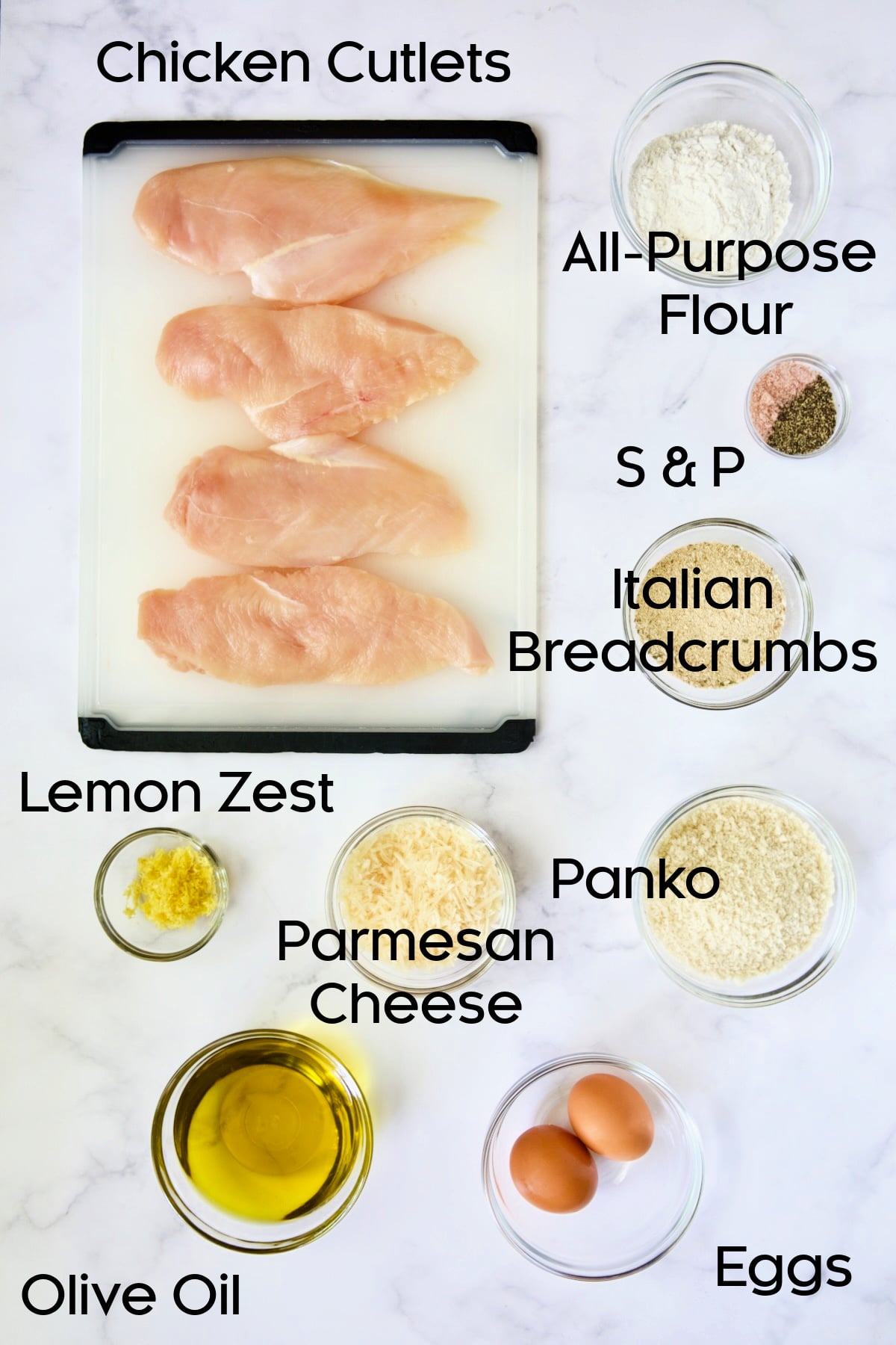 Ingredients for Chicken Milanese in glass bowls.