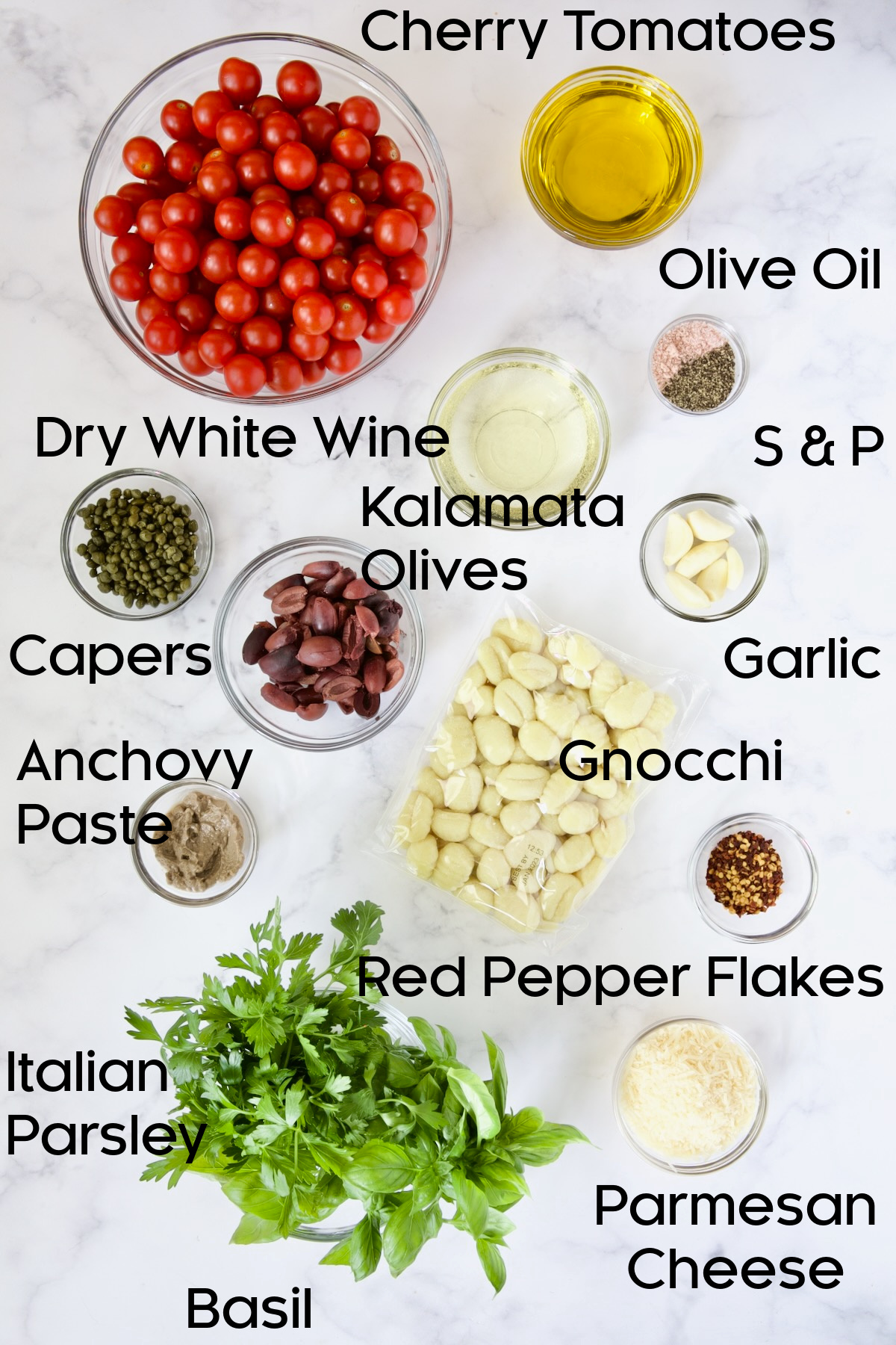 Ingredients for the recipe in glass bowls on marble surface.
