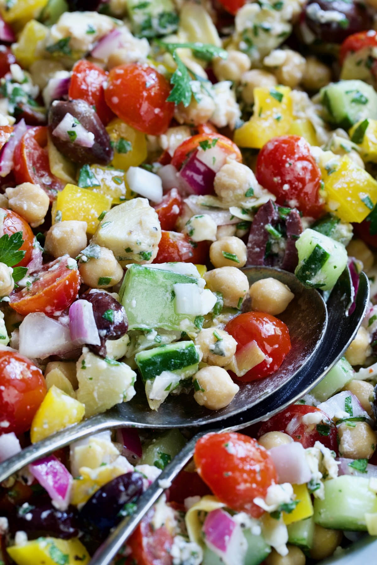Close-up photo of the salad with serving utensils.