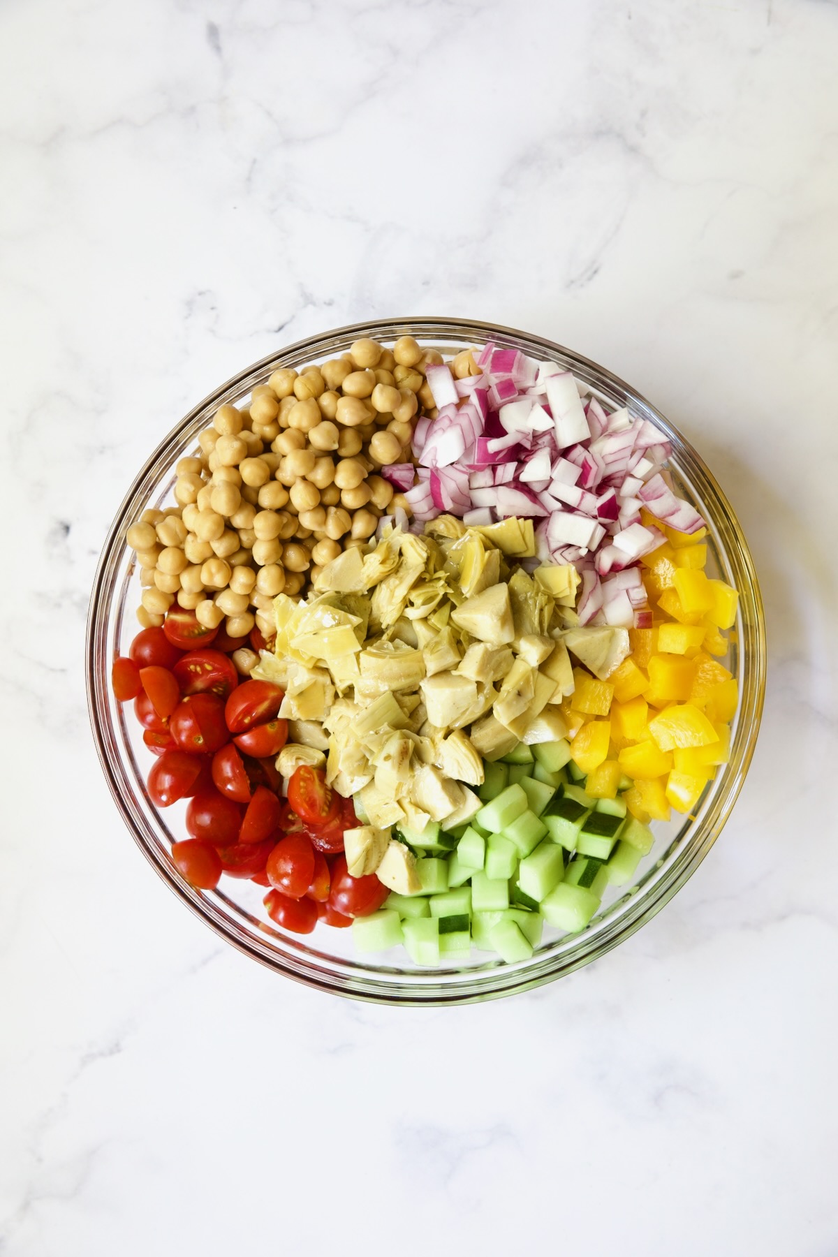 Ingredients for the salad in glass bowl before being combined.