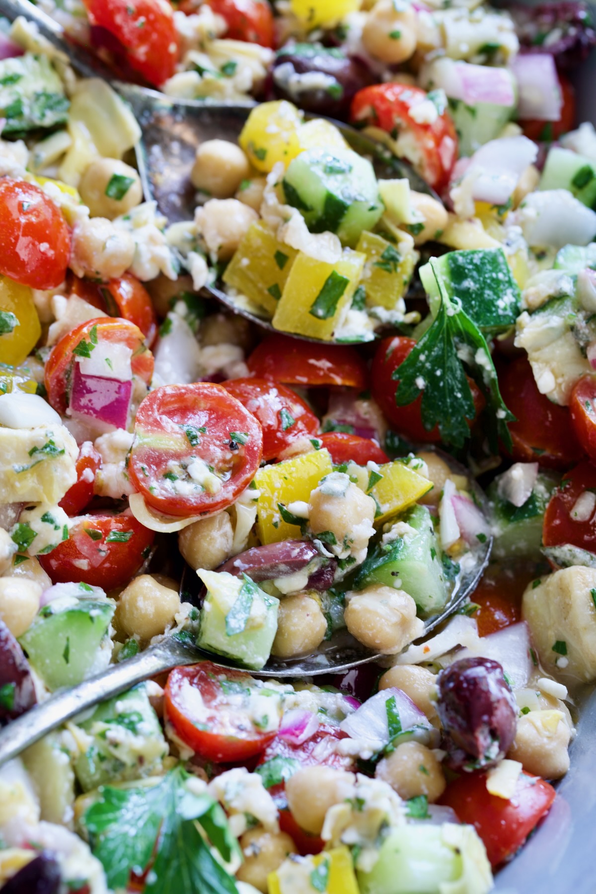 Two spoons scooping up the salad.