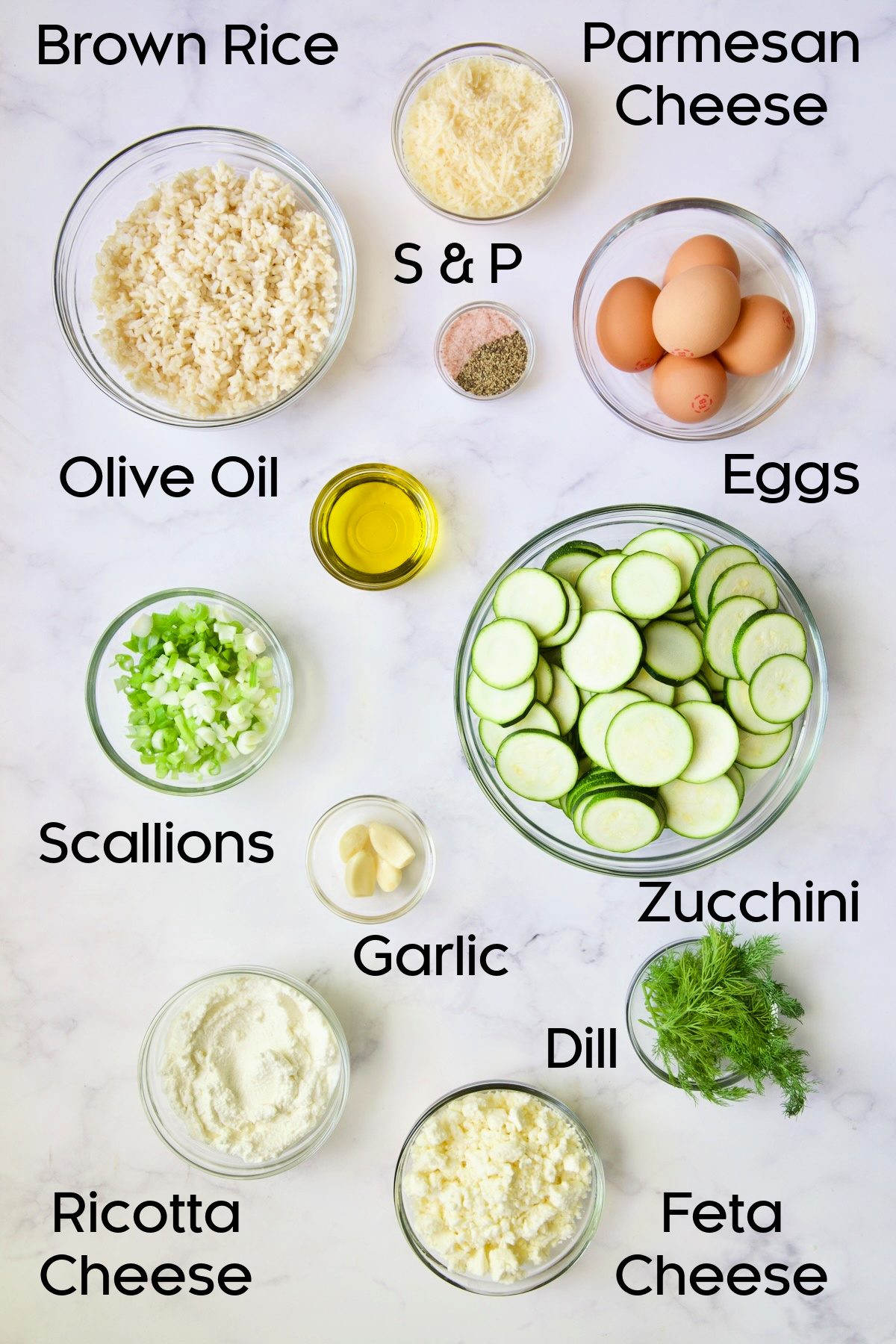 Ingredients for Zucchini Pie with Feta Cheese in glass bowls.