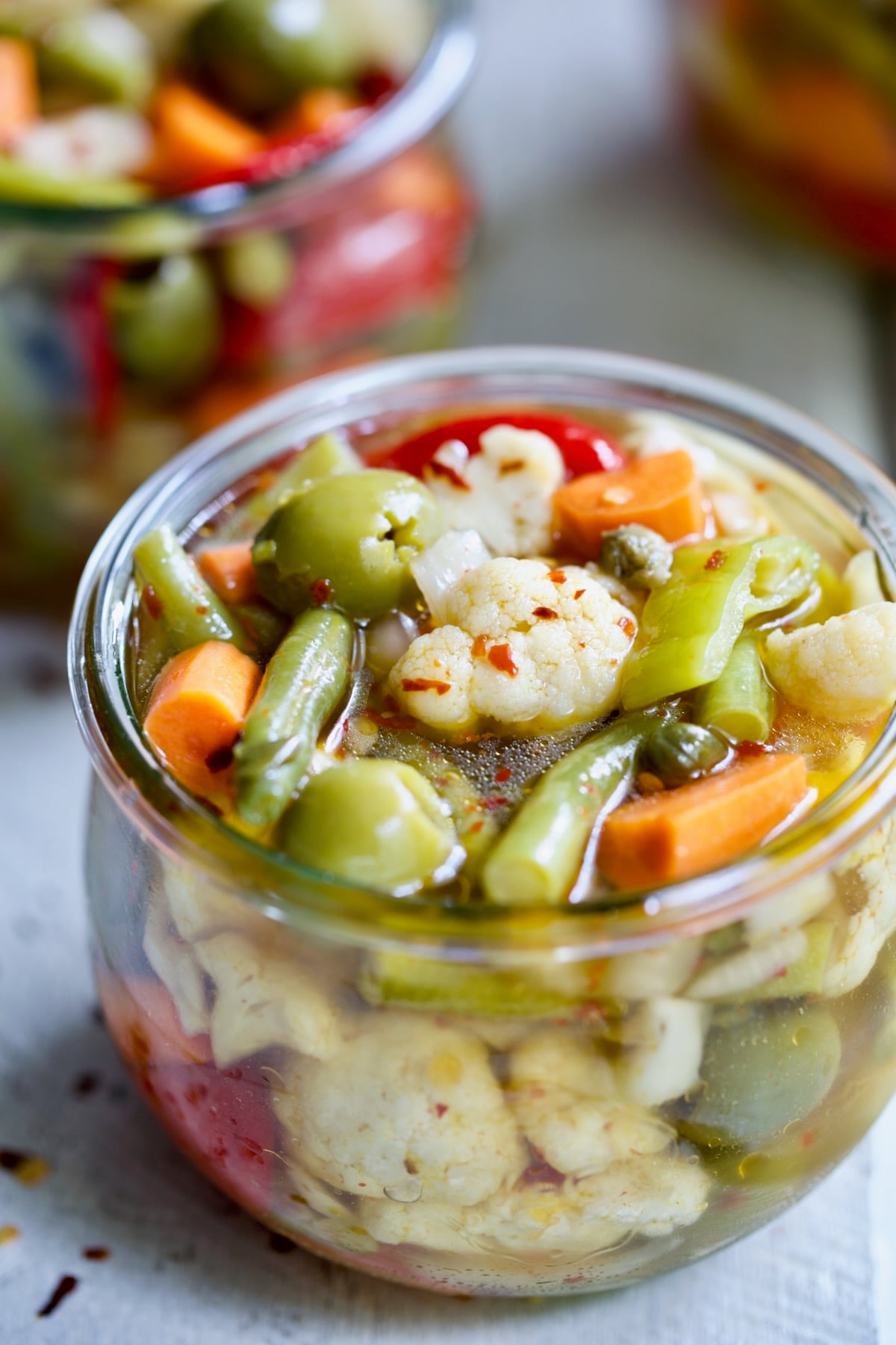 Finished Giardiniera (Italian Pickled Vegetables) in a glass jar.