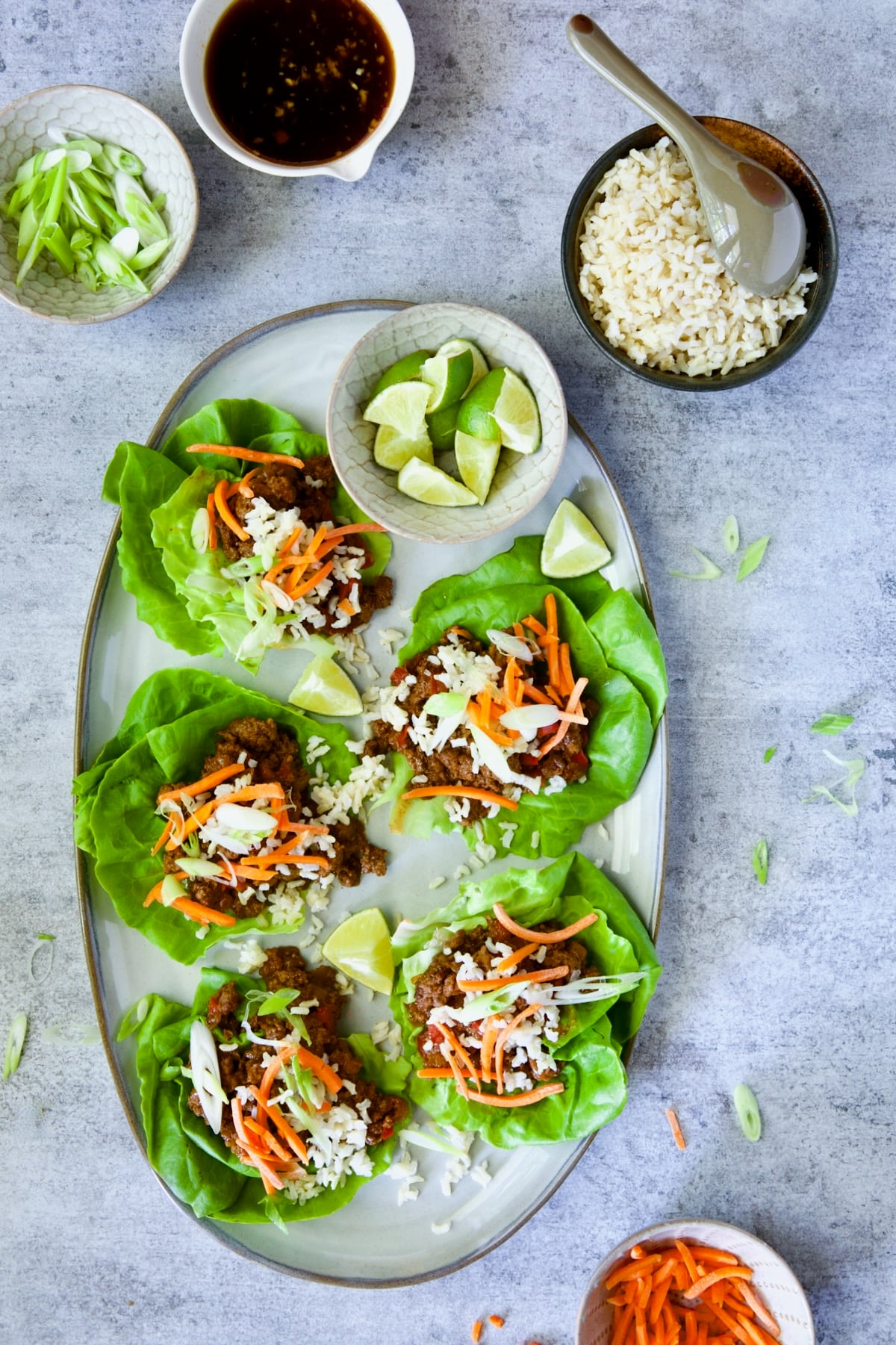Beef Lettuce Wraps Recipe with Lime Ginger Dipping Sauce on blue background.