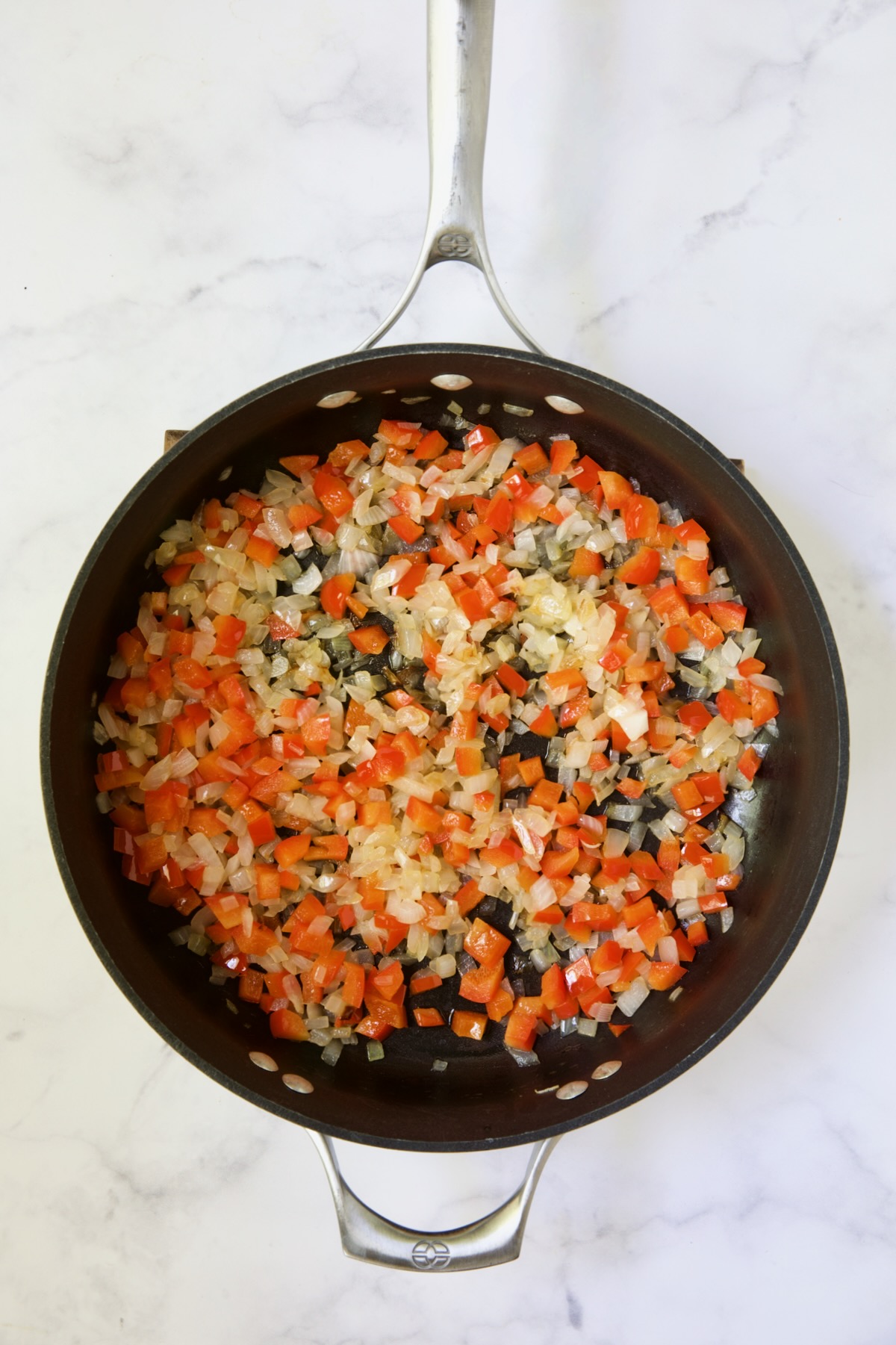 Cooked onion and red bell pepper in nonstick skillet.