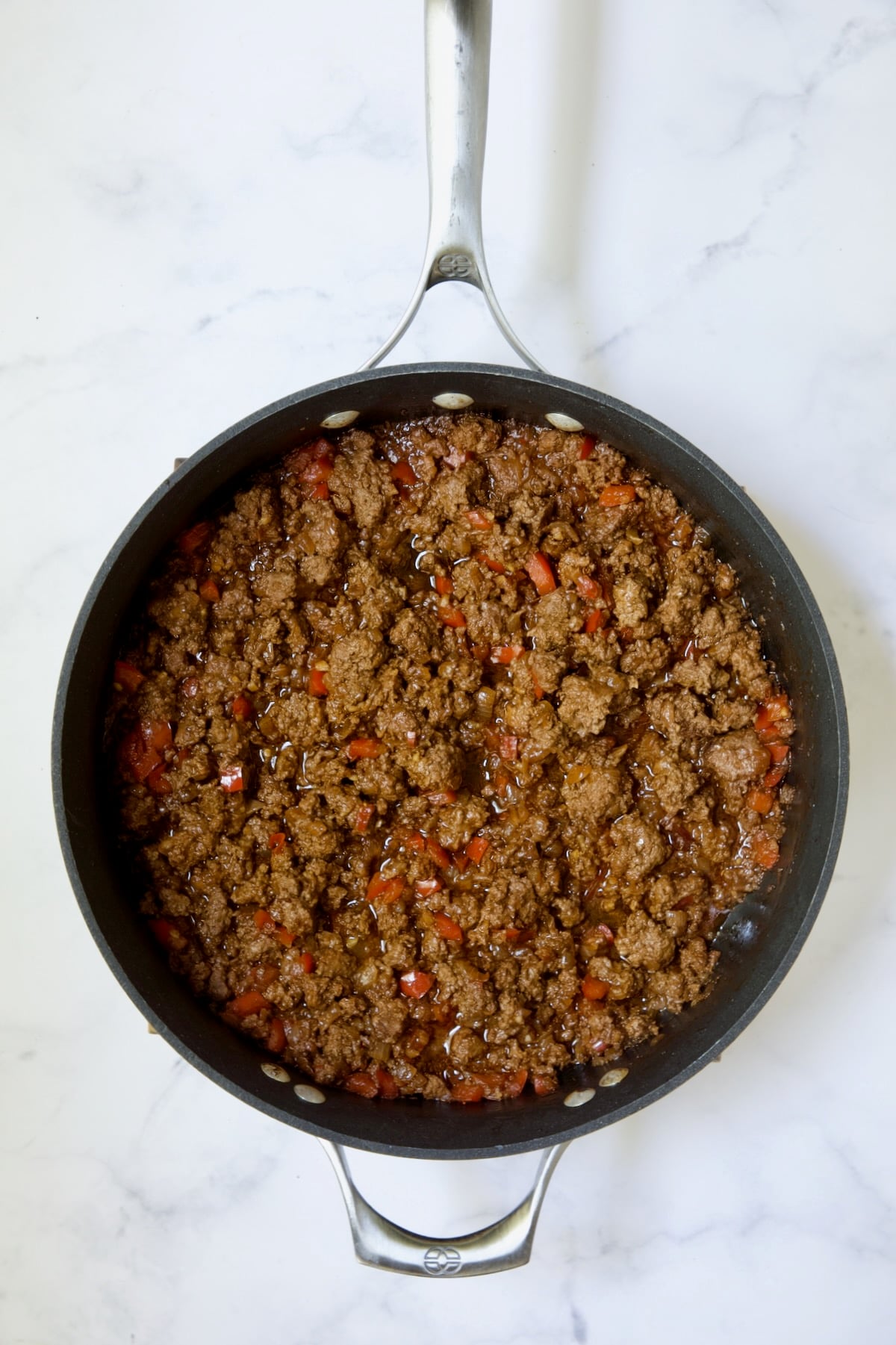 Cooked ground beef filling in nonstick skillet.