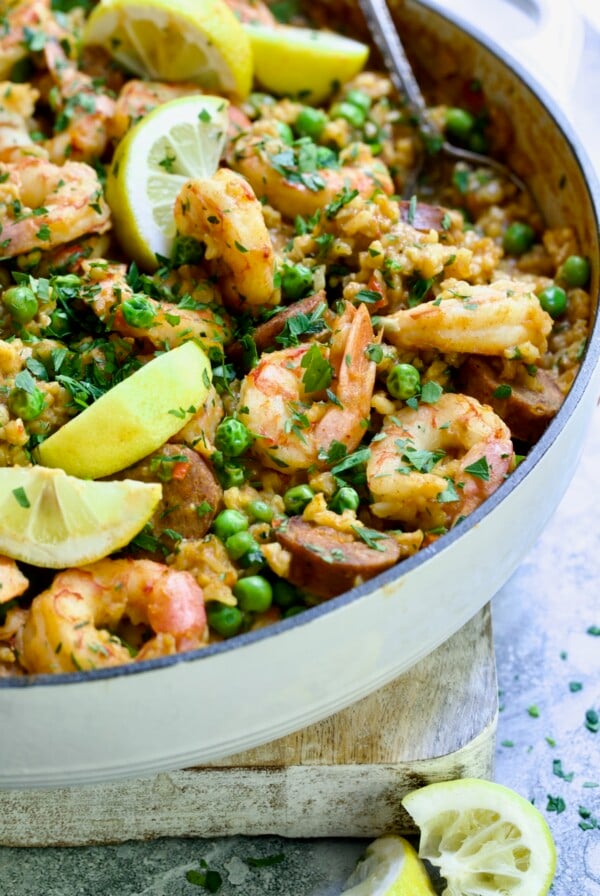 Brown Rice Paella with Shrimp and Chorizo with lemon wedges.