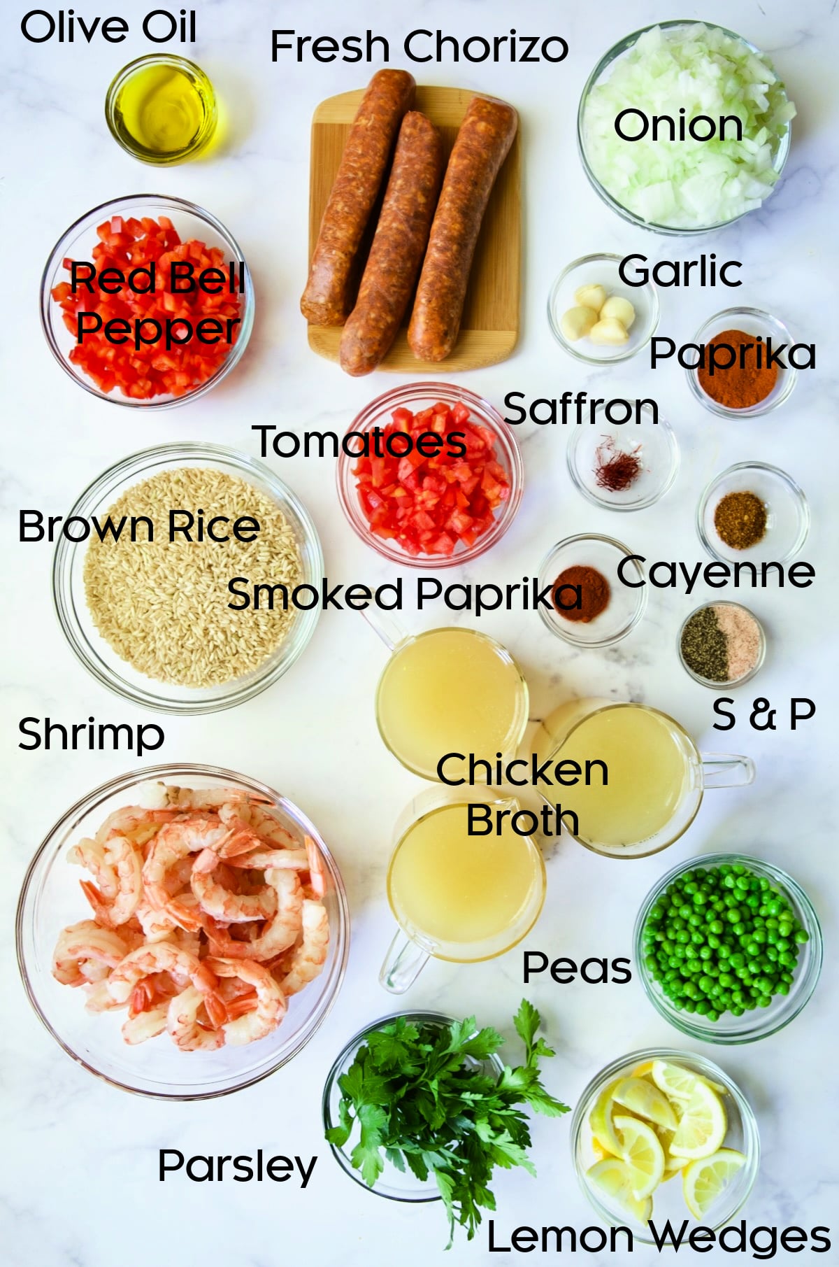 Ingredients for Brown Rice Paella with Shrimp and Chorizo in glass bowls.