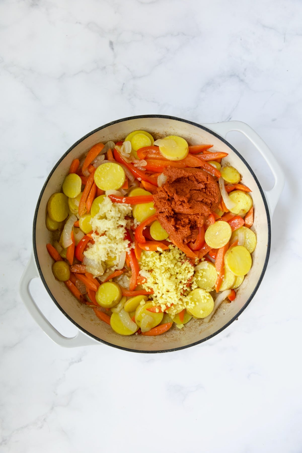 Process shot with potatoes, red bell pepper and curry paste, ginger and garlic added.