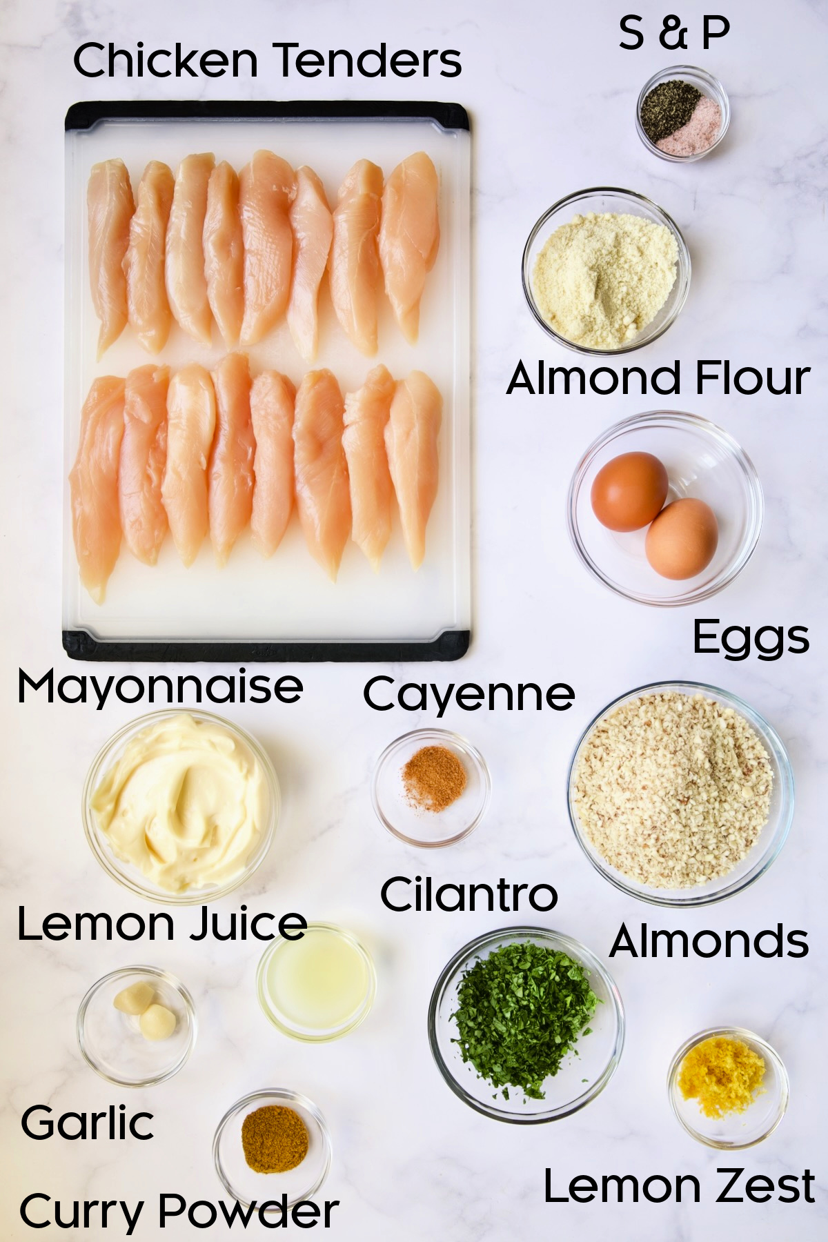 Ingredients for Almond-Crusted Chicken Tenders with Lemon Curry Mayonnaise in glass bowls.