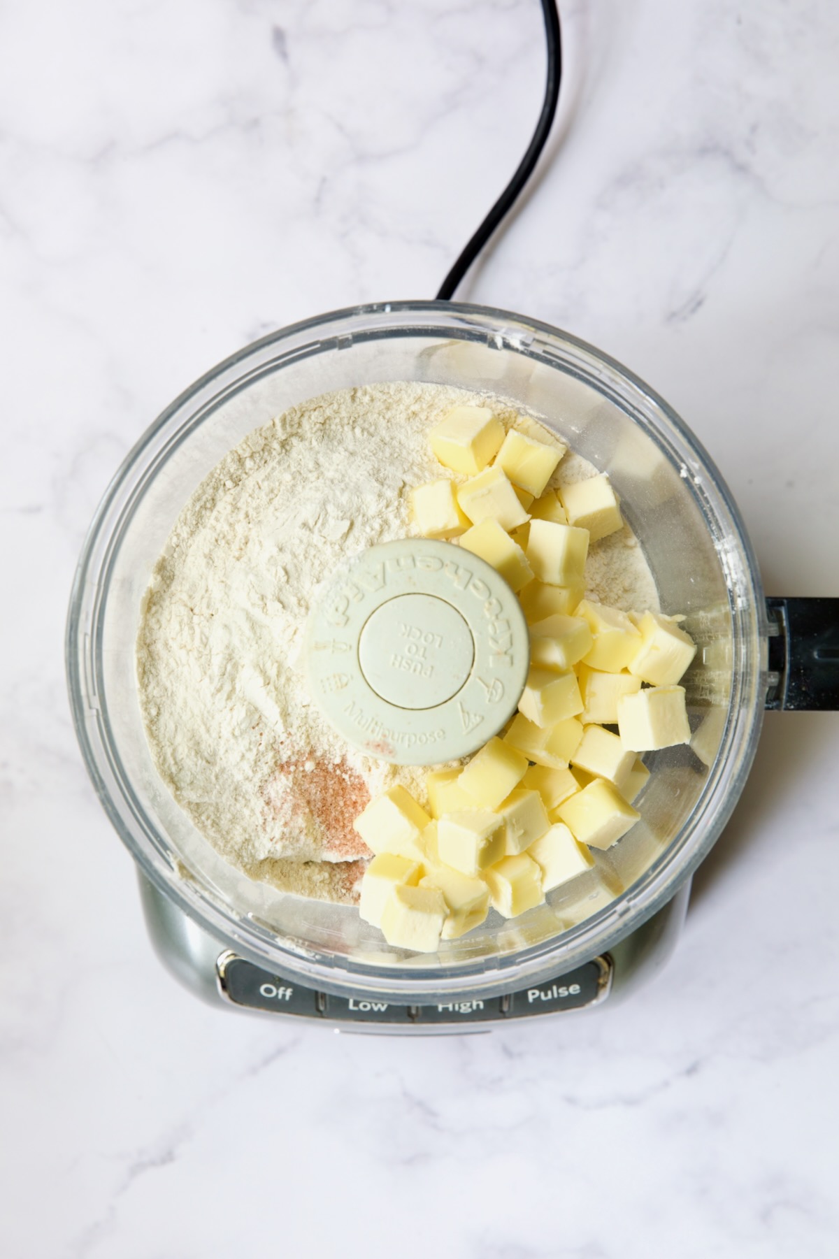 Flour, butter cubes and salt in food processor before being incorporated.