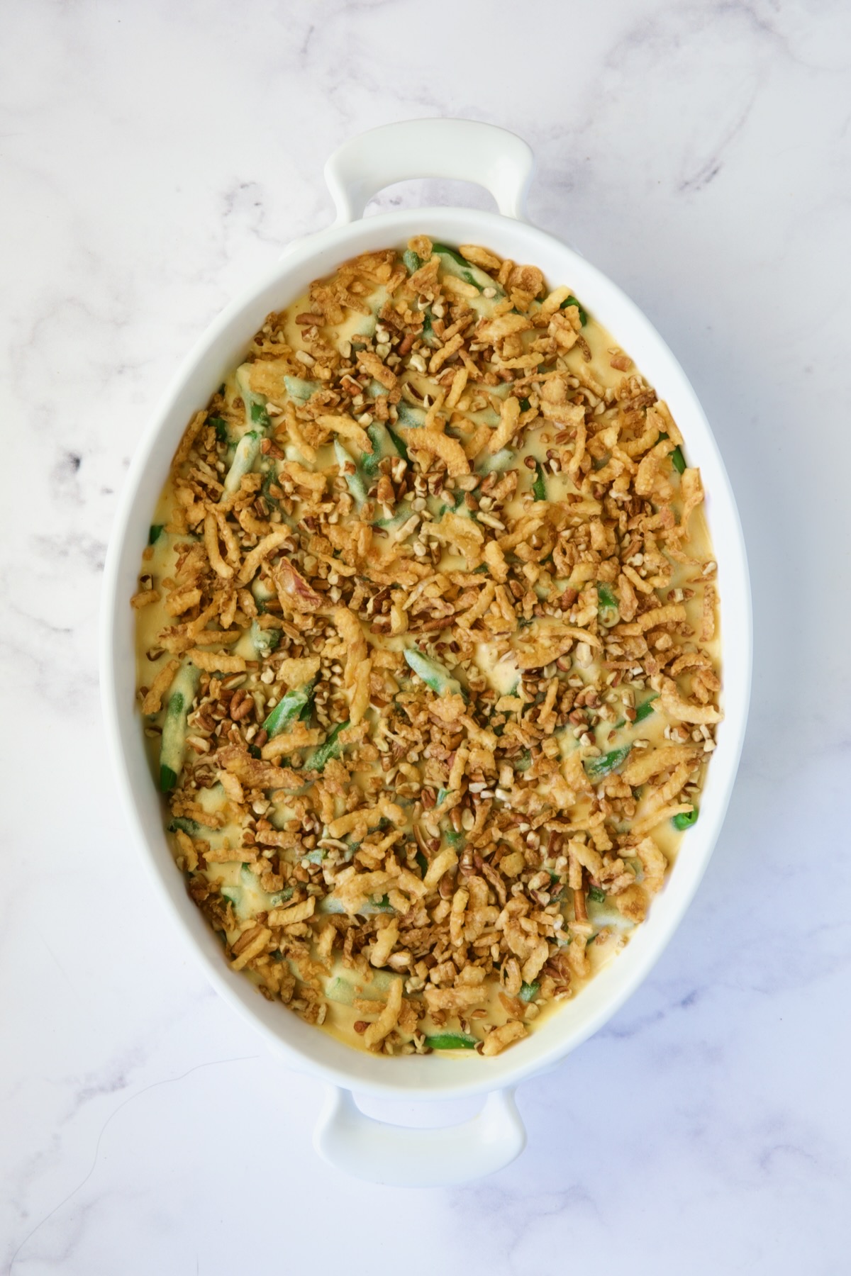 Unbaked green bean casserole fully assembled.