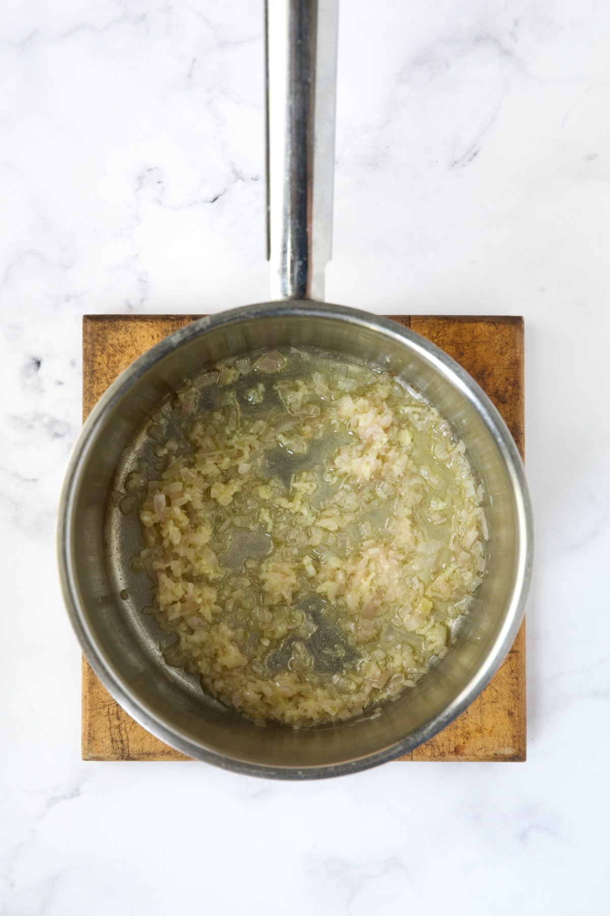 Shallots and garlic in butter in stainless steel saucepan.