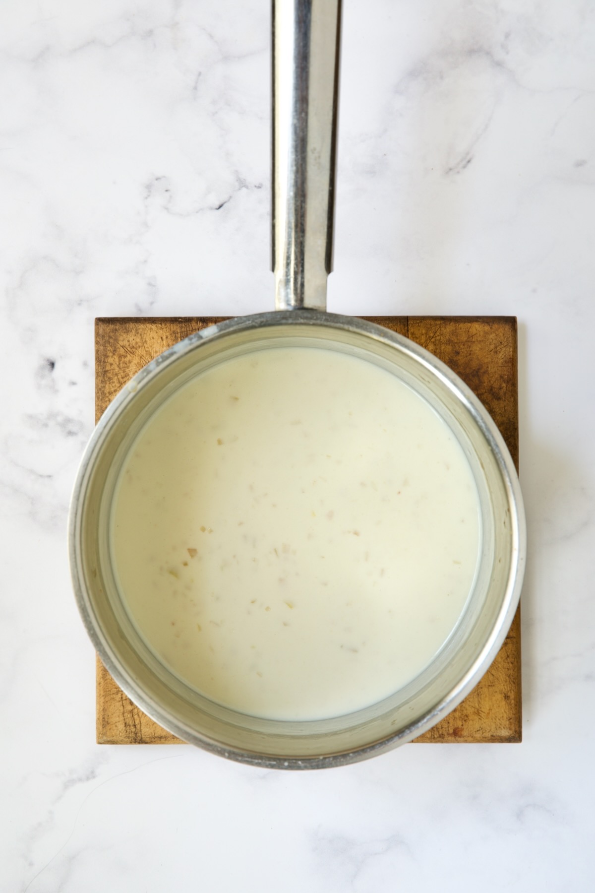 Sauce for green beans in stainless steel saucepan before cheese is added.